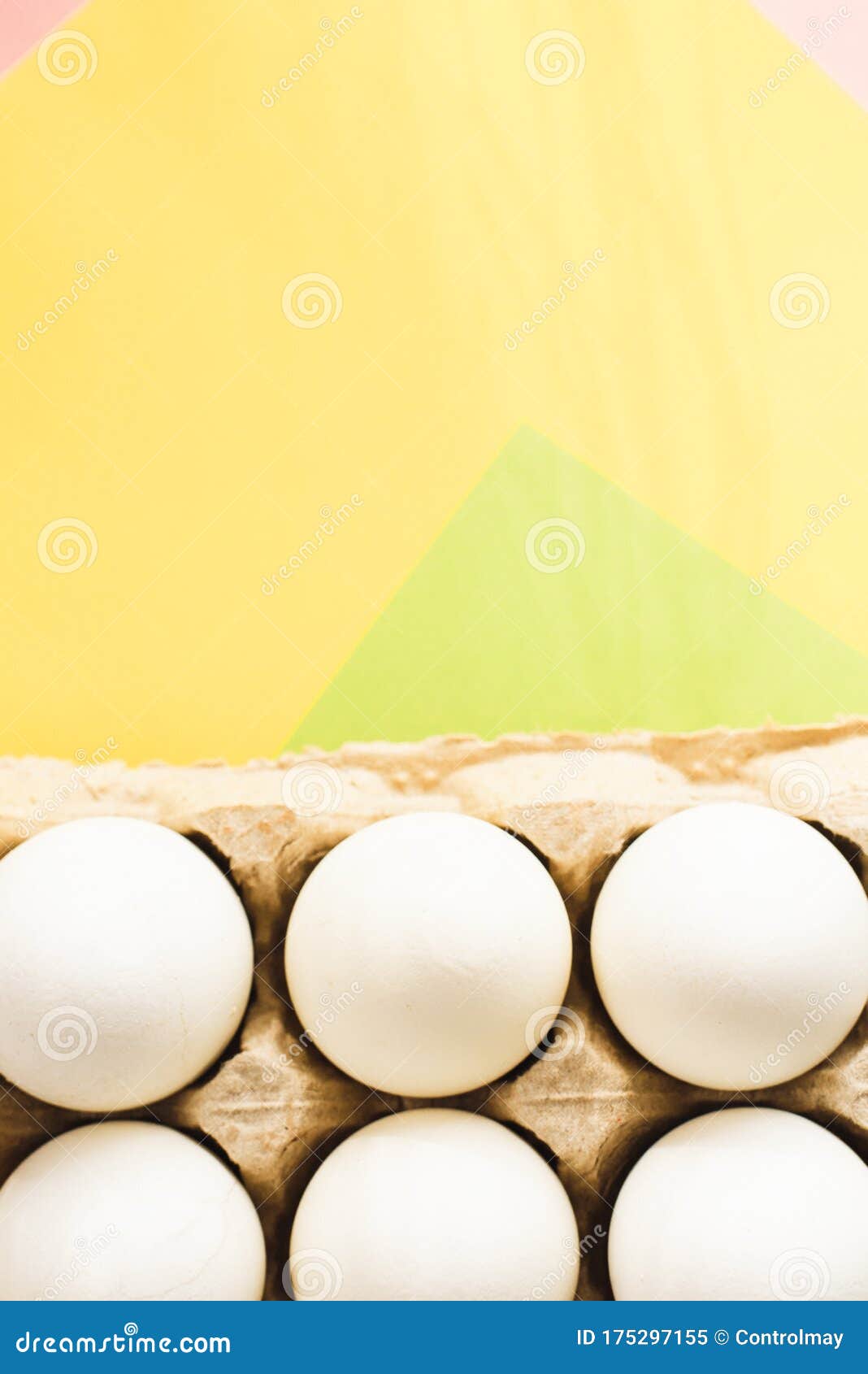top view of white chicken eggs in an open egg carton on colorful background. copy space. natural healthy food and organic farming