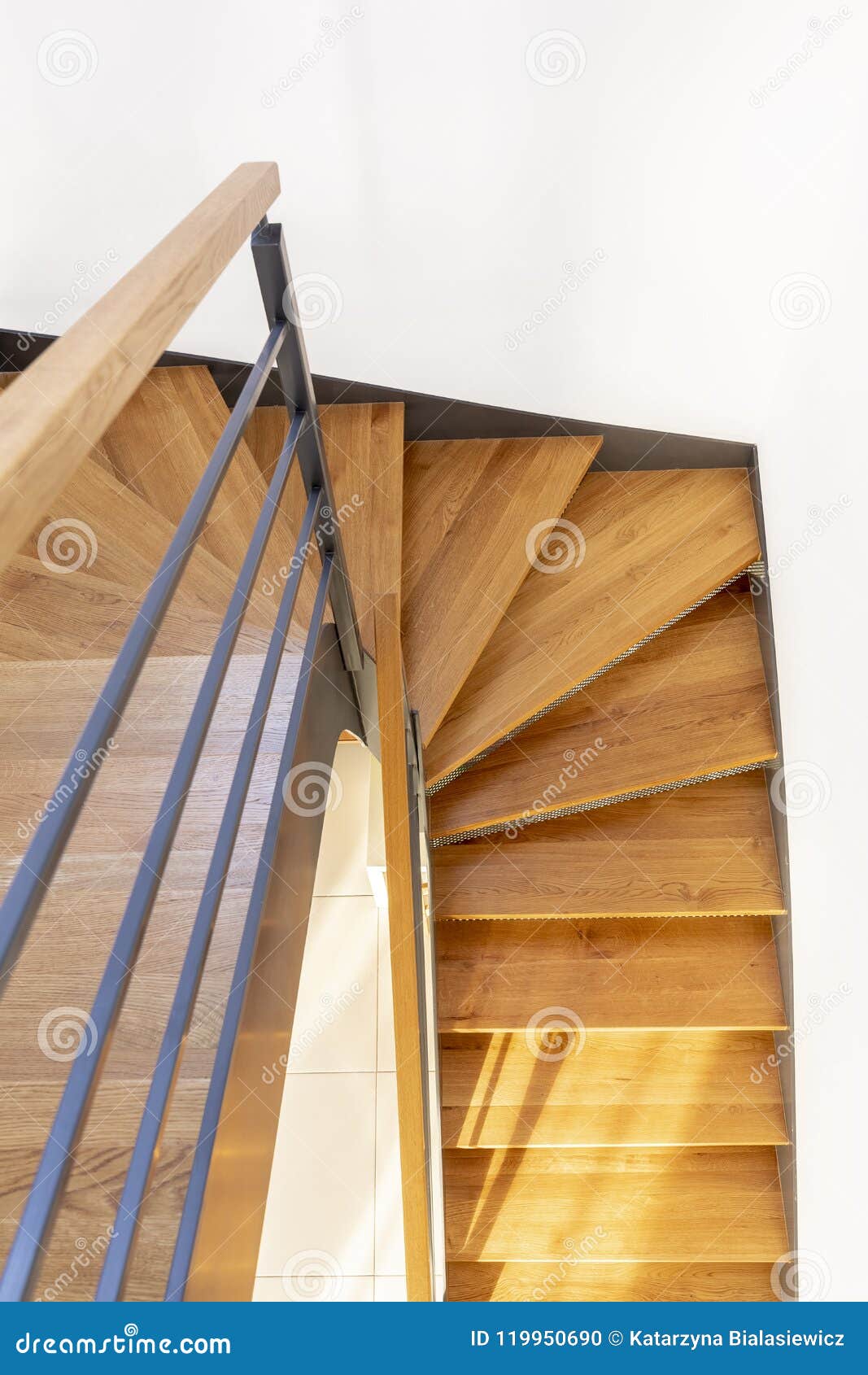 Top View Of A Wooden Staircase With White Wall And Metal