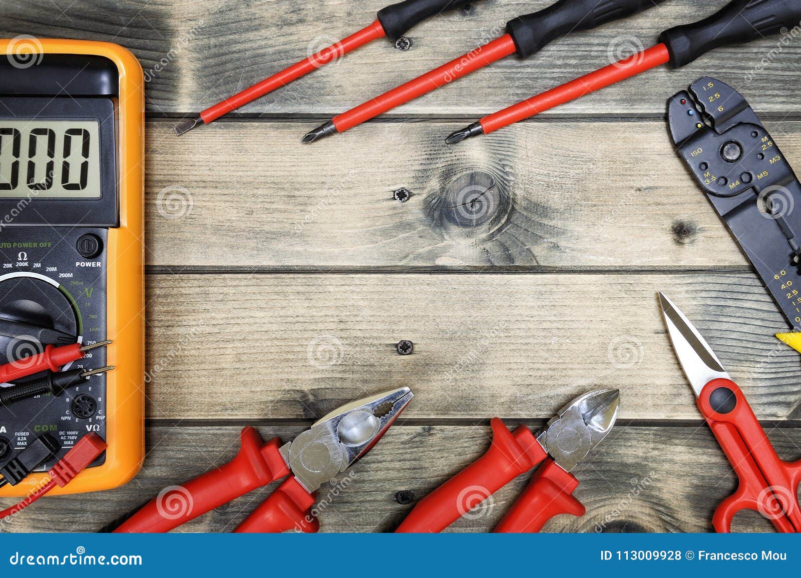 top view of work tools for residential electrical installation on antique wooden background.