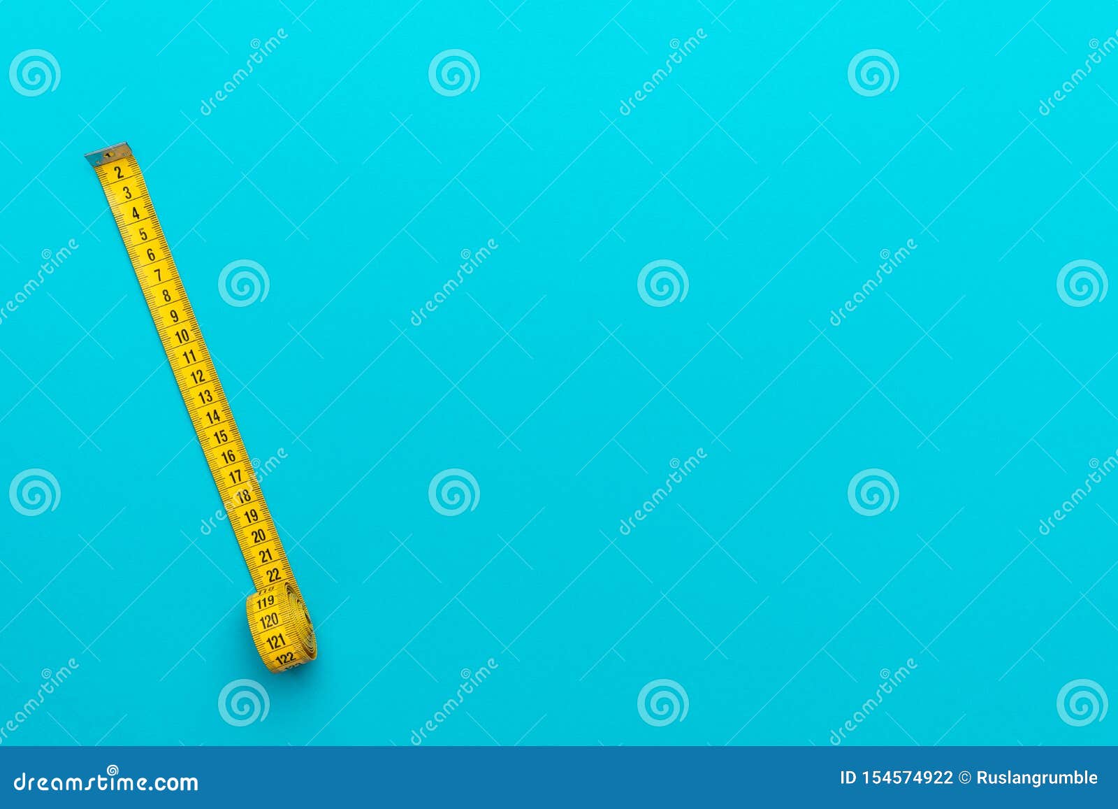 Top view of yellow soft measuring tape. Minimalist flat lay image of tape  measure with metric