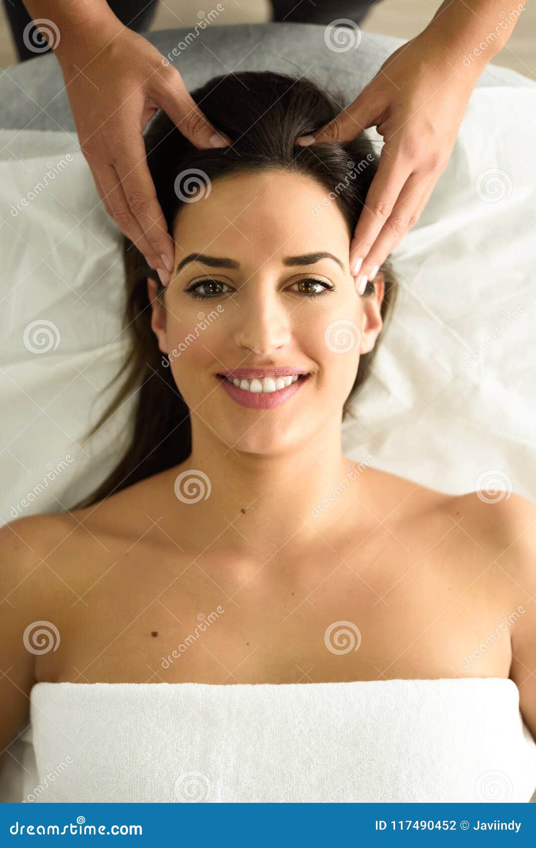 Young Smiling Woman Receiving A Head Massage In A Spa Center Stock