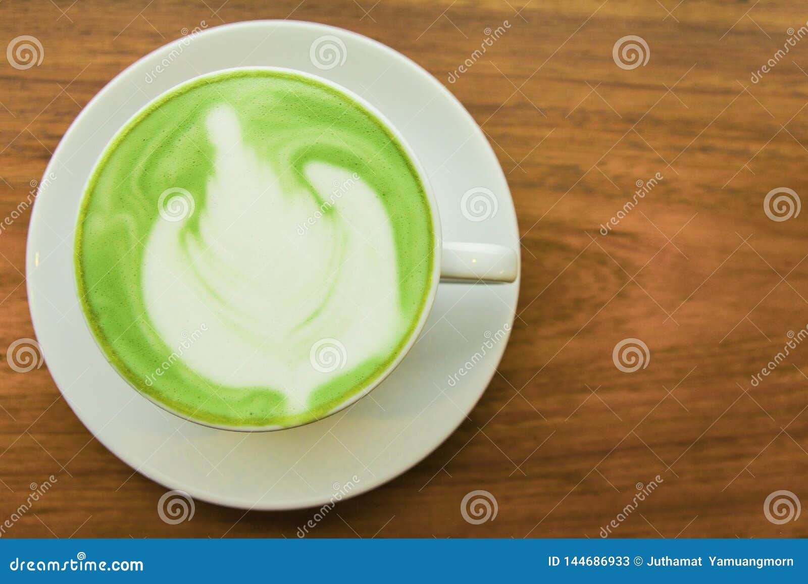 top viwe. milk green tea latte in cup on wood