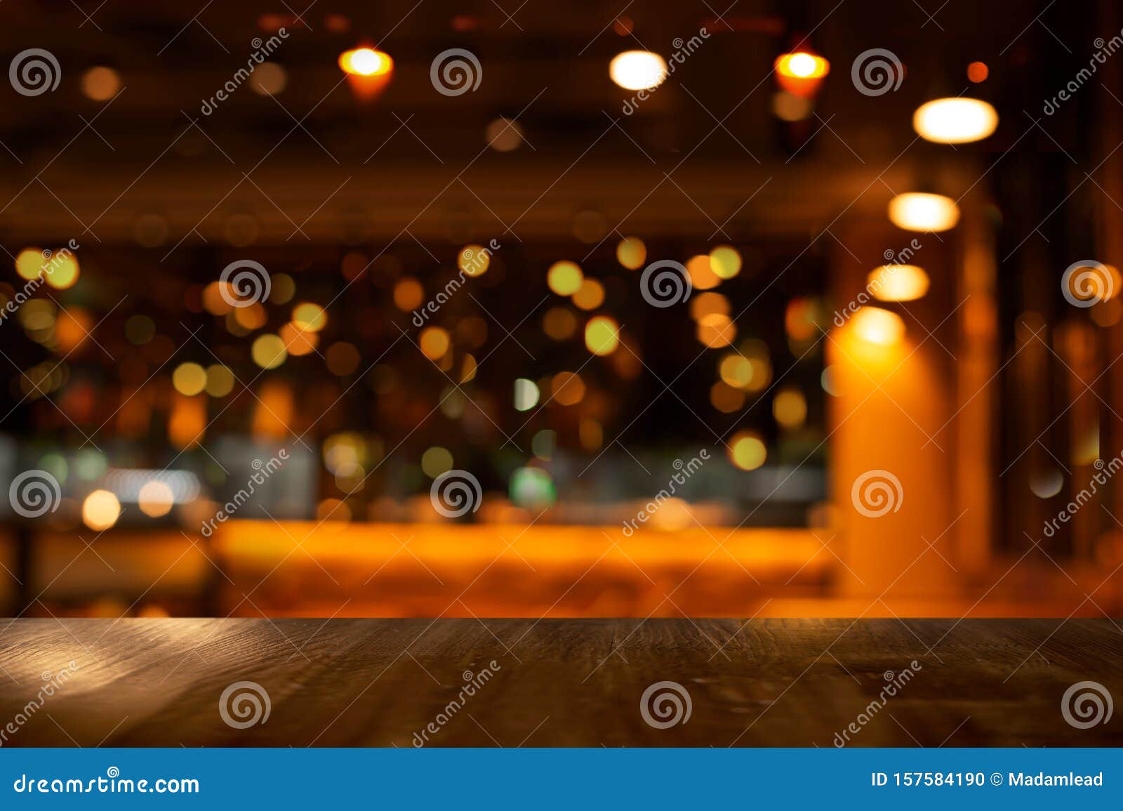 top of wood table with bokeh of glor blur lamp light in party bar or pub in the christmas night background