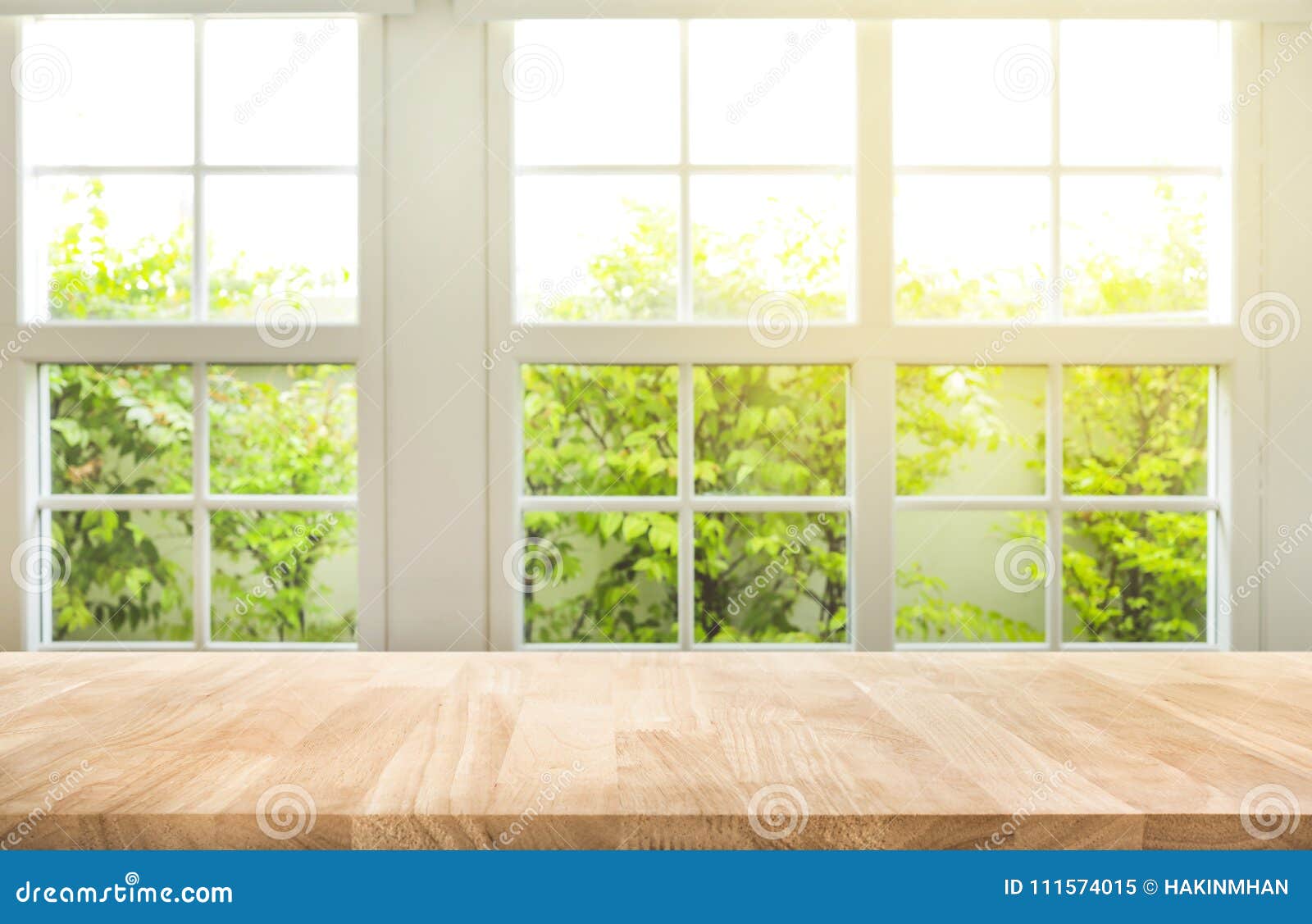 top of wood table counter on blur window view garden background.