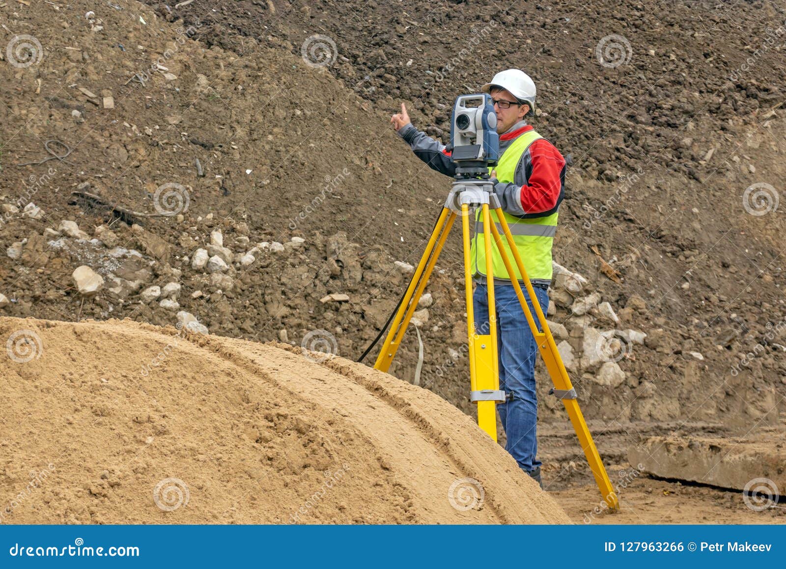 topographical survey of the terrain by a surveyor at the construction site