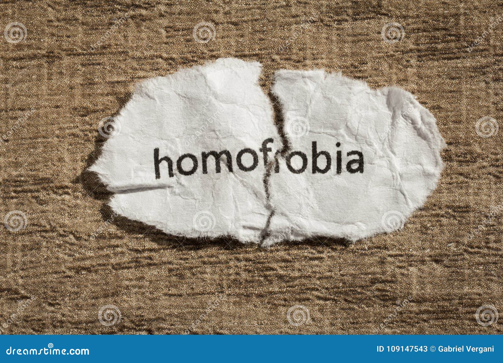 torn paper written homofobia, portuguese and spanish word for ho