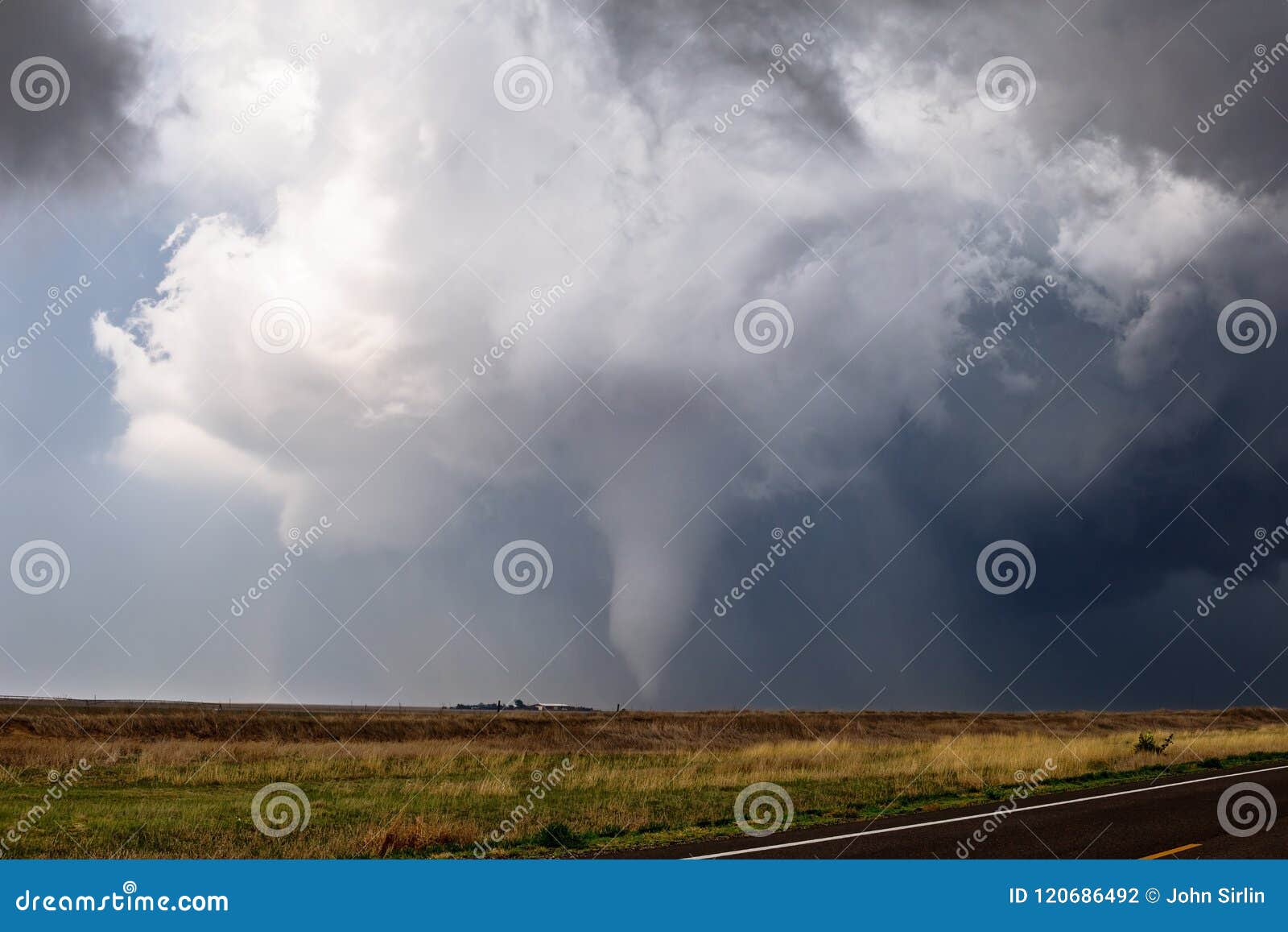 tornado spins across a field near ensign, kansas.