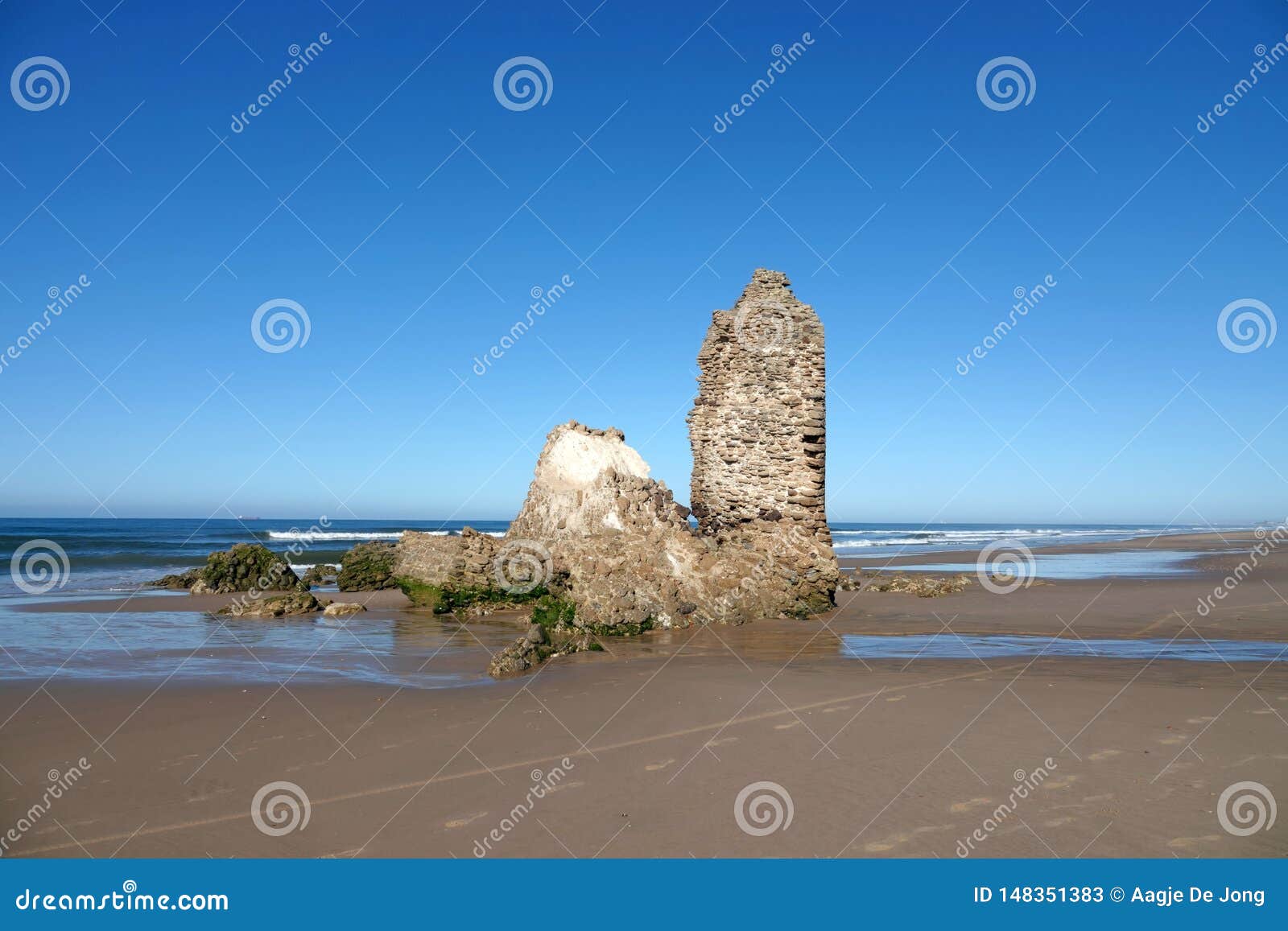 torre del loro mazagon at playa de rompeculos beach in mazagon, spain