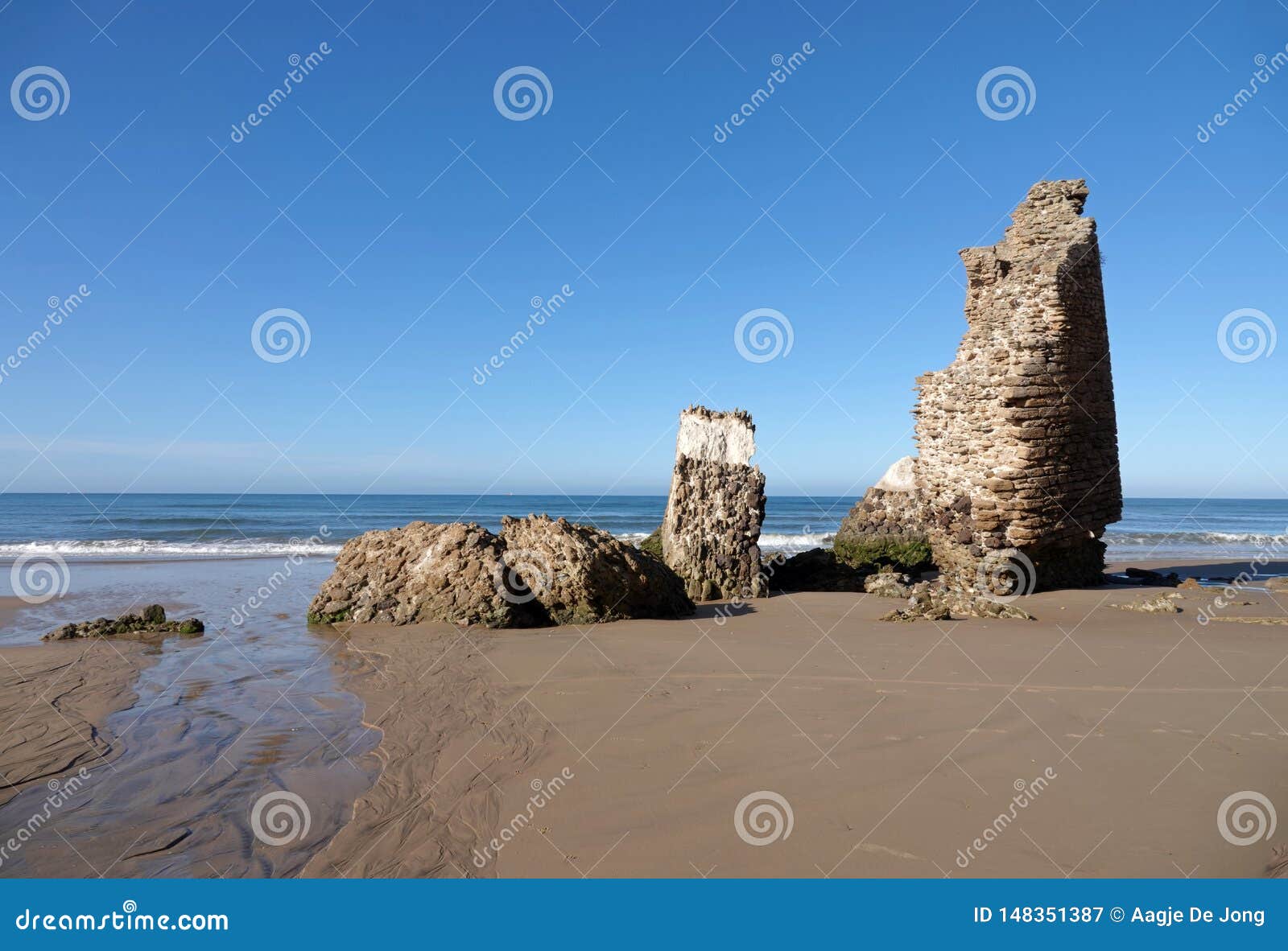 torre del loro mazagon ruin at playa de rompeculos beach in mazagon, spain