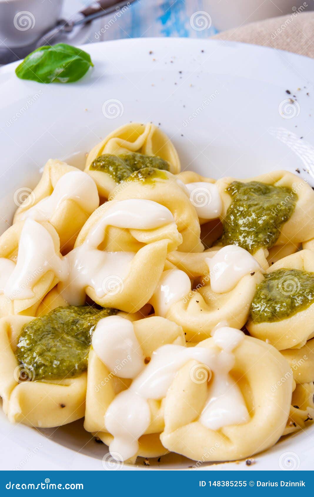 A Tortellini Di Formaggio with Basil Pesto and Cheese Sauce Stock Image