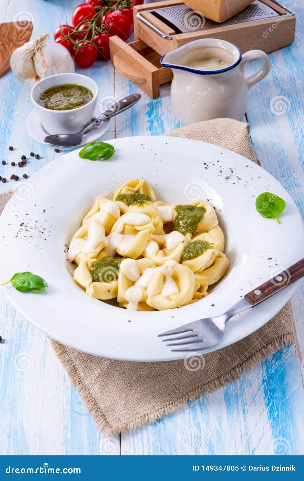 A Tortellini Di Formaggio with Basil Pesto and Cheese Sauce Stock Image