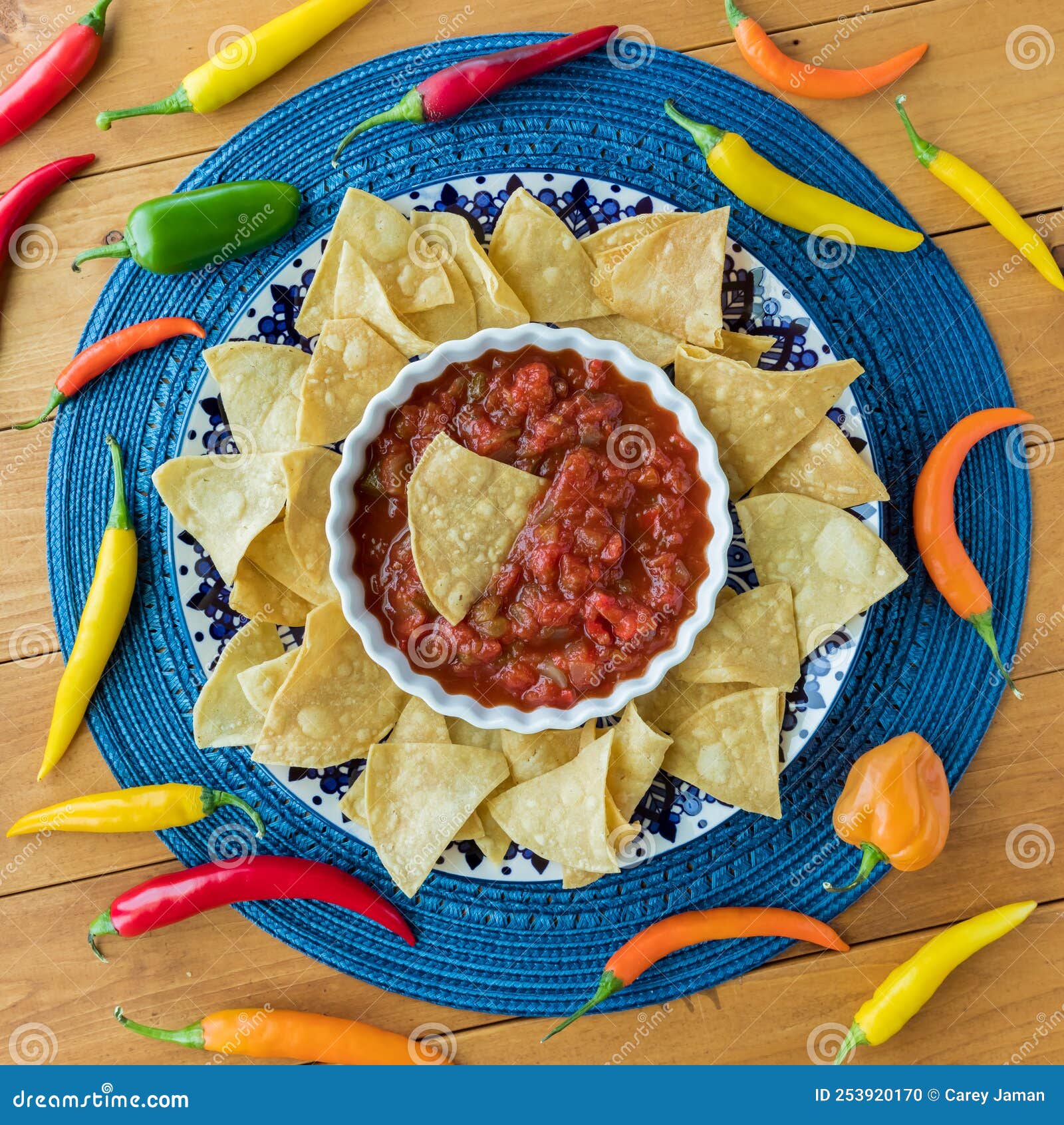 Tortilla Chips and Salsa Surrounded by Colourful Chilli Peppers. Stock