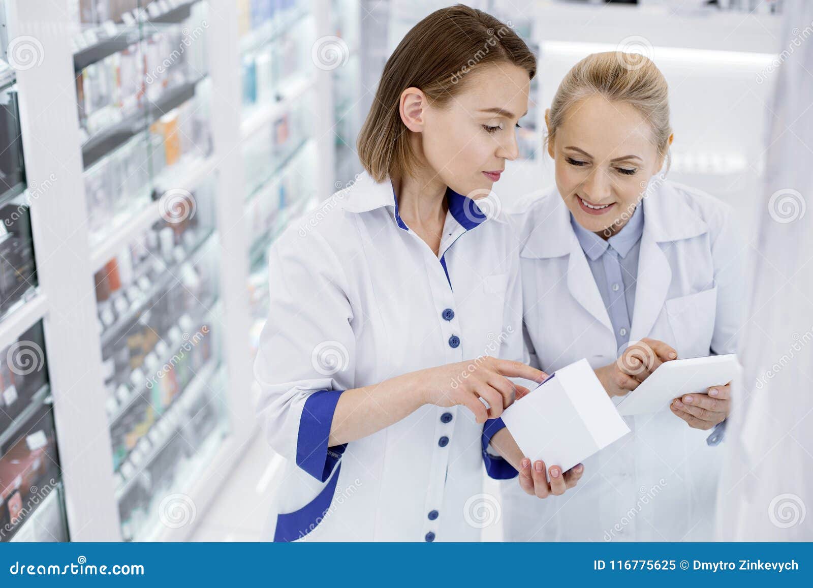 Attentive Female Pharmacists Checking Medication Stock Image - Image of ...