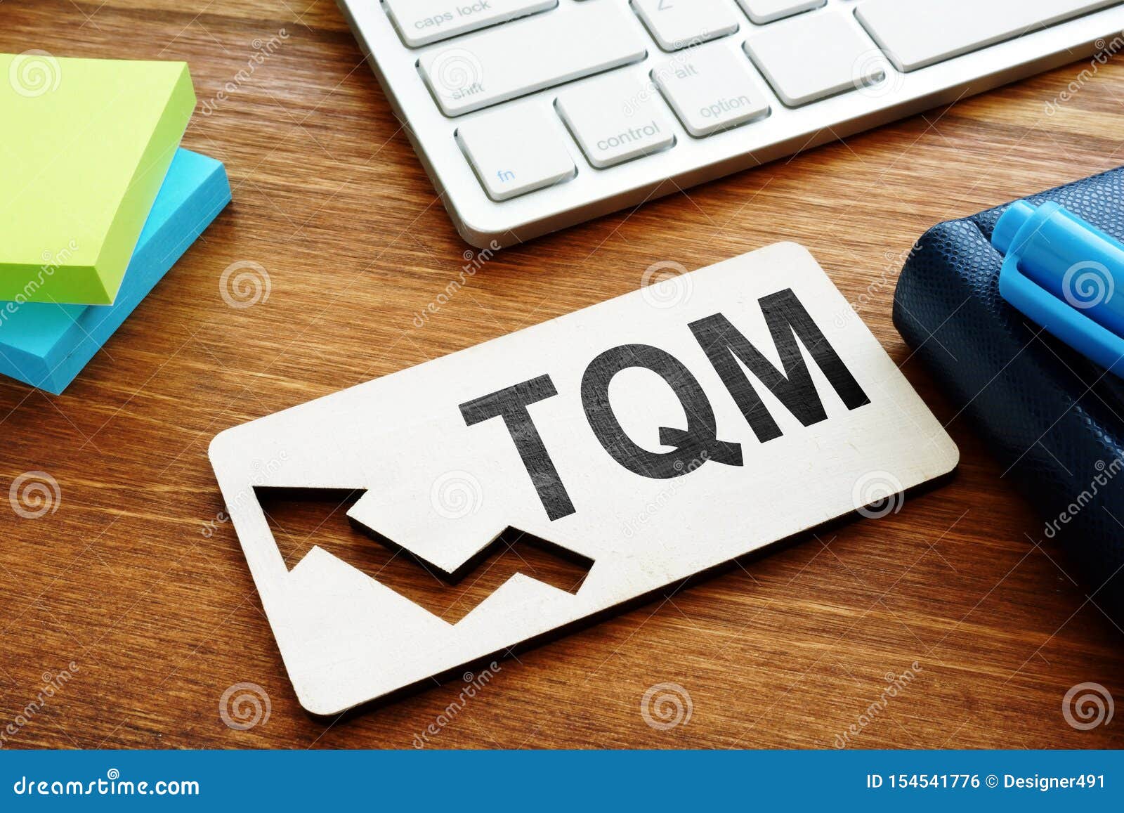 total quality management tqm concept. report on a desk