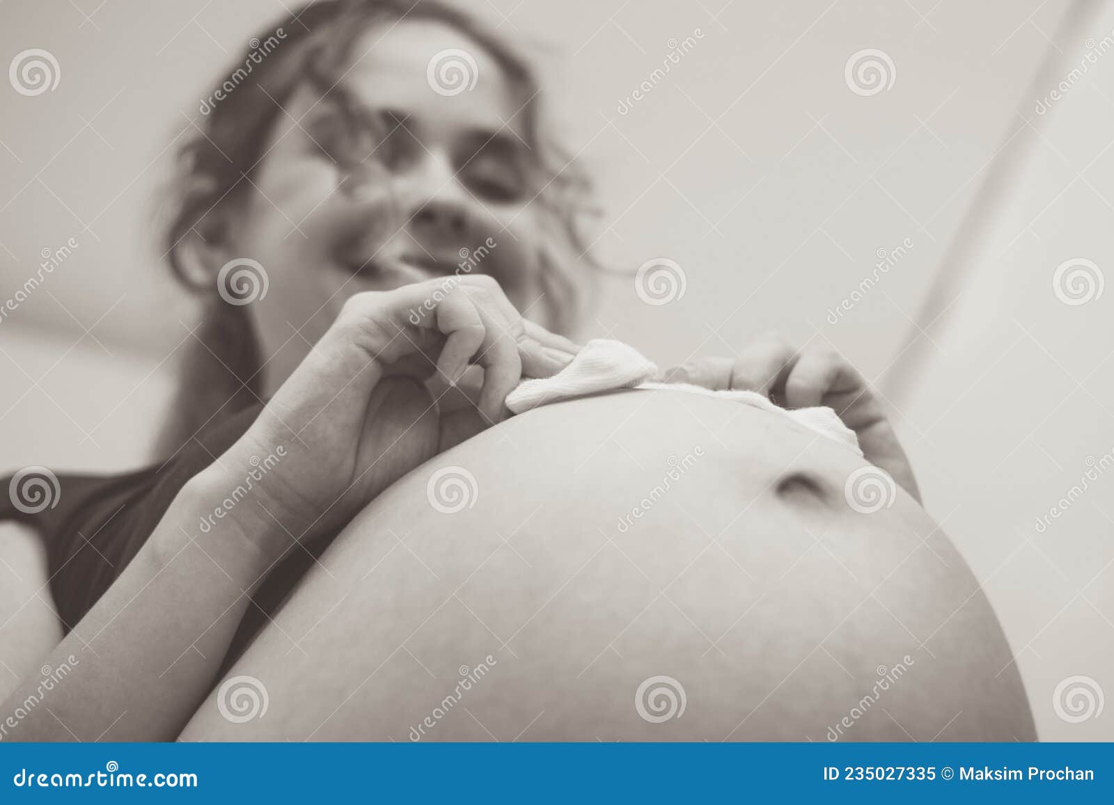 https://thumbs.dreamstime.com/z/touching-photo-happy-pregnancy-moments-young-expectant-mother-socks-her-belly-235027335.jpg