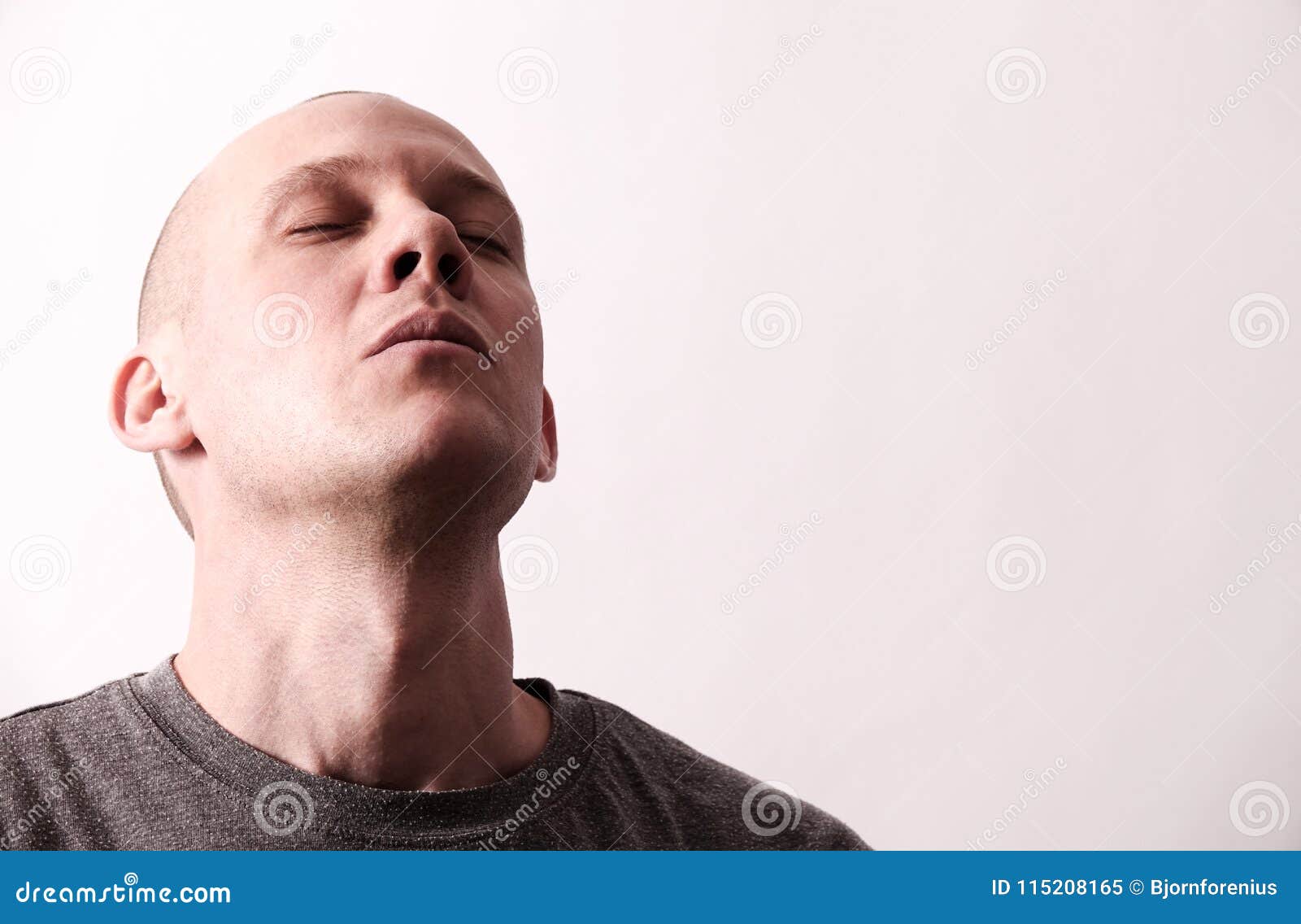 tough looking guy takes a deep breath