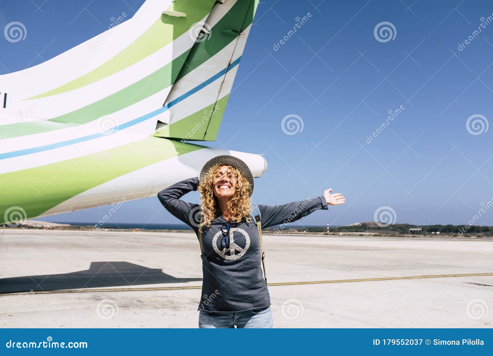 tourism and tourist travel happy people concept with cheerful and joyful adult beautiful woman ready to leave with the aircraft