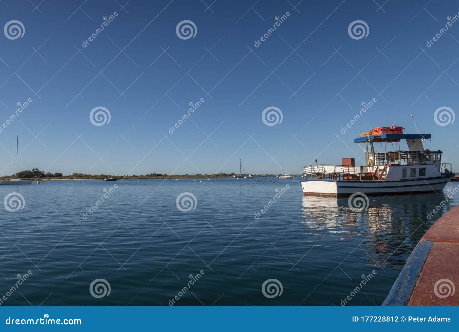 tourist boat moored on the gilao river near tavira, portugal