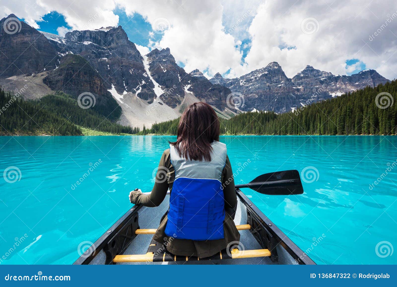 tourist canoeing on moraine lake in banff national park, canadian rockies, alberta, canada