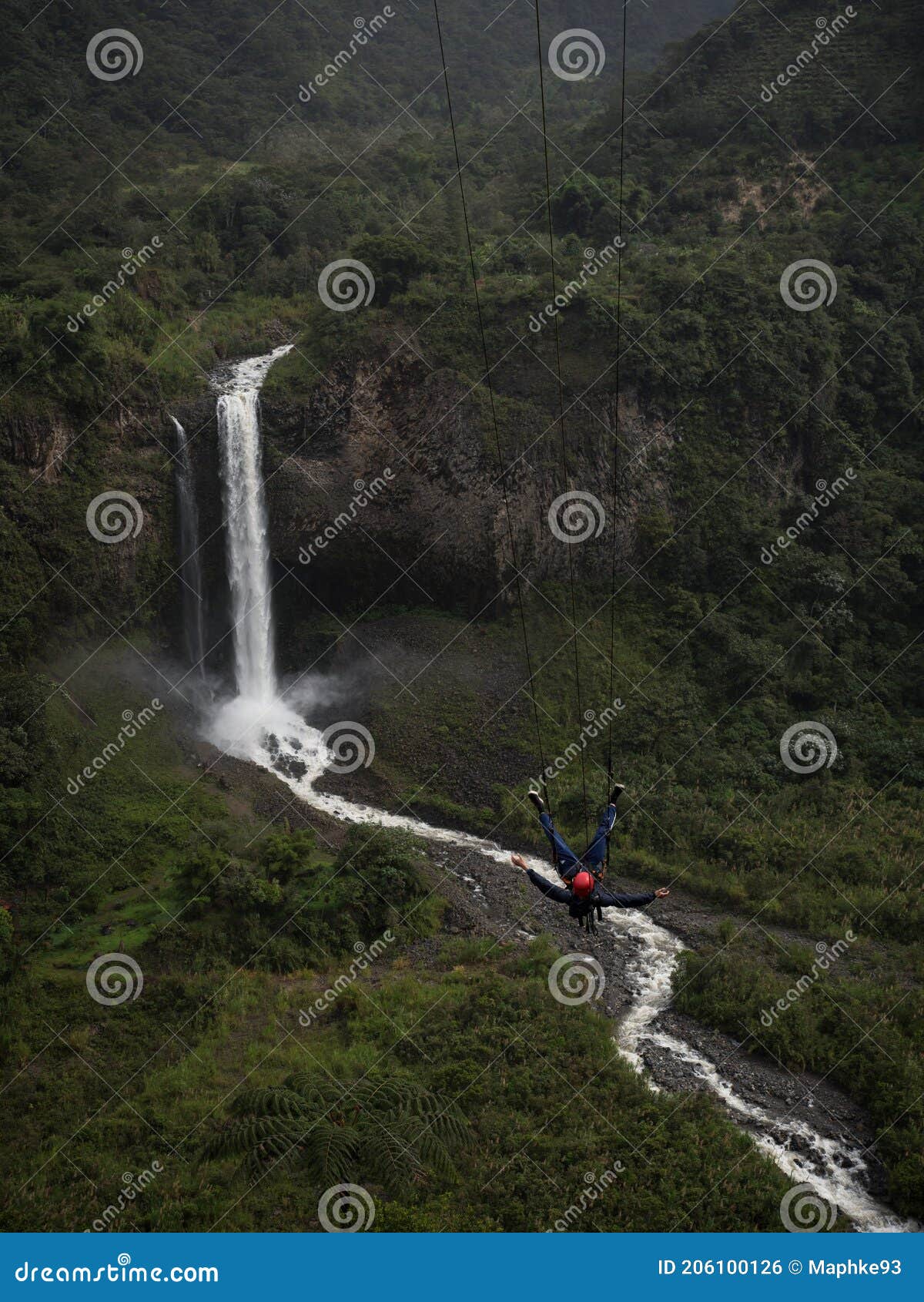 tourist on giant swing adventure ride at manto de la novia bridal veil waterfall pastaza river banos tungurahua ecuador