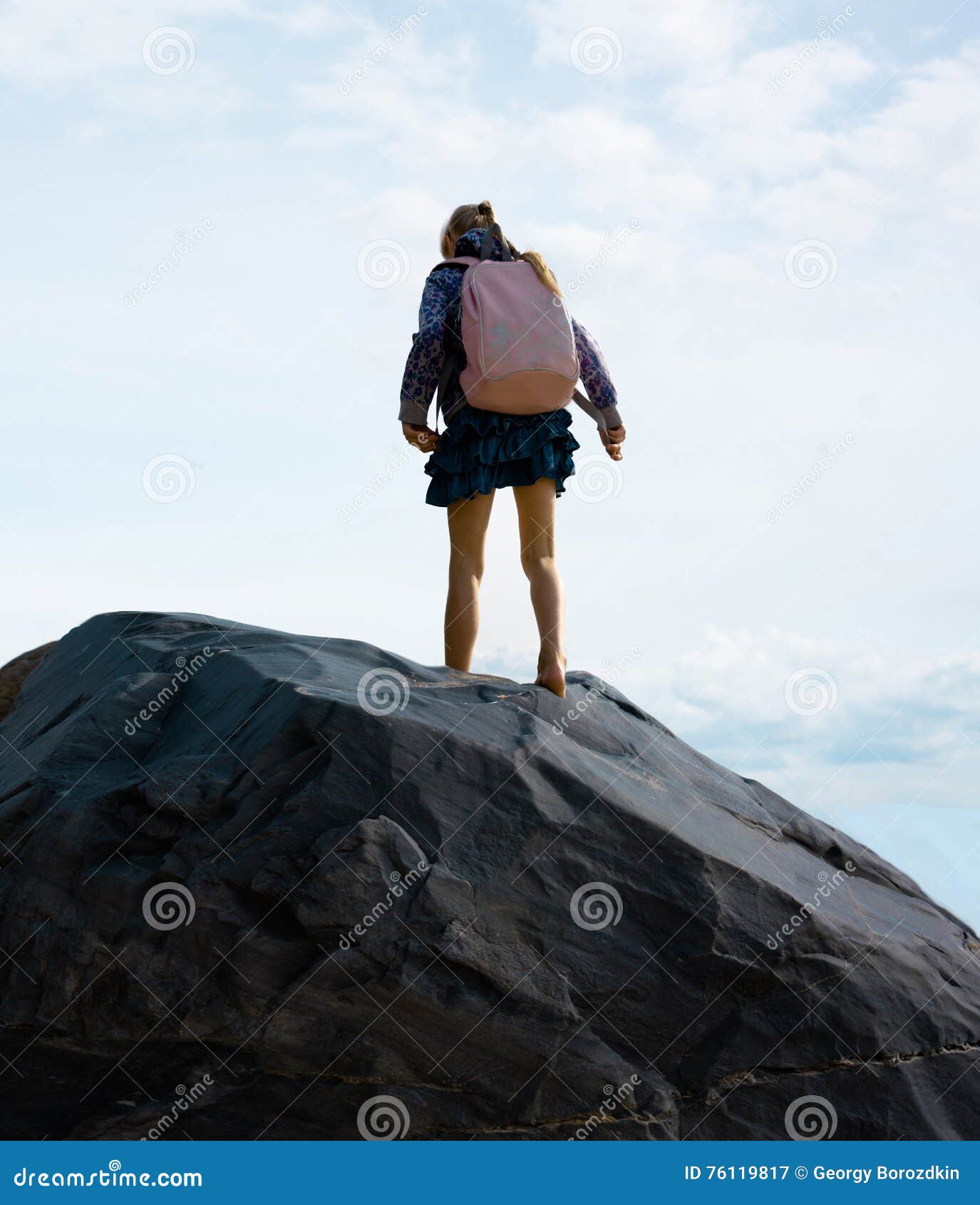 Tourist. girl standing on the mountain the background clouds. Girl standing on the peak of the mountain look at the rising sun