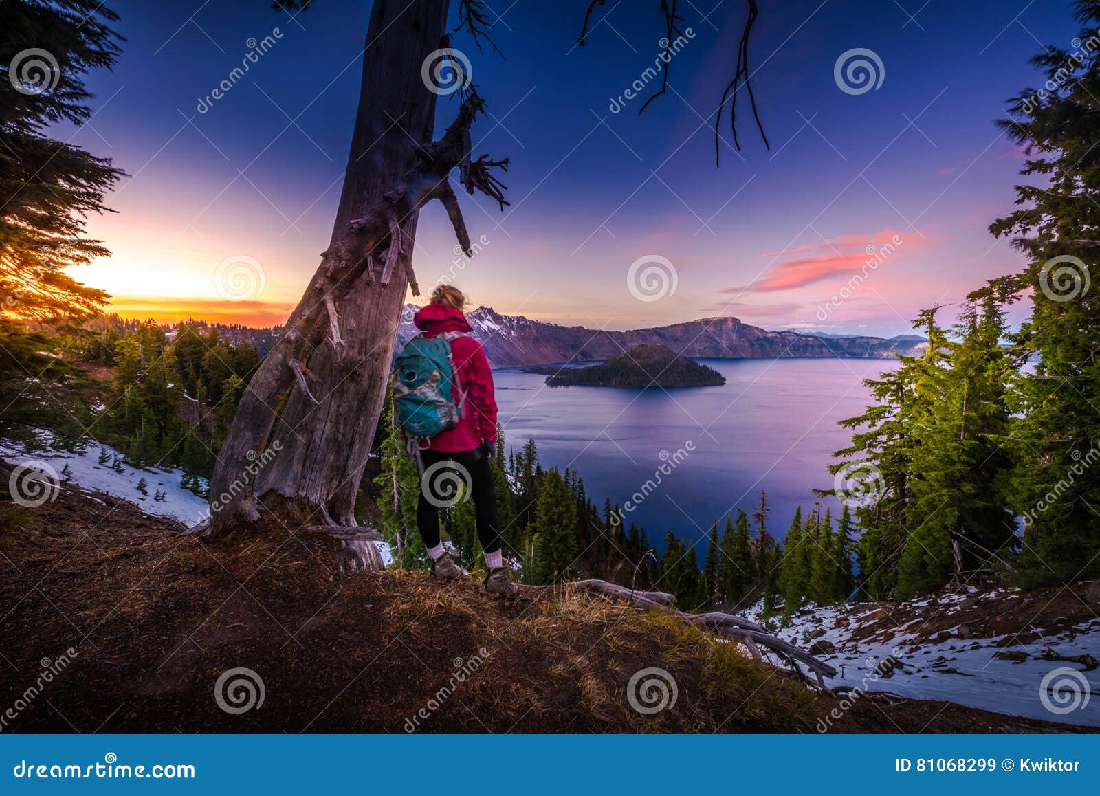 tourist looking at crater lake oregon landscape