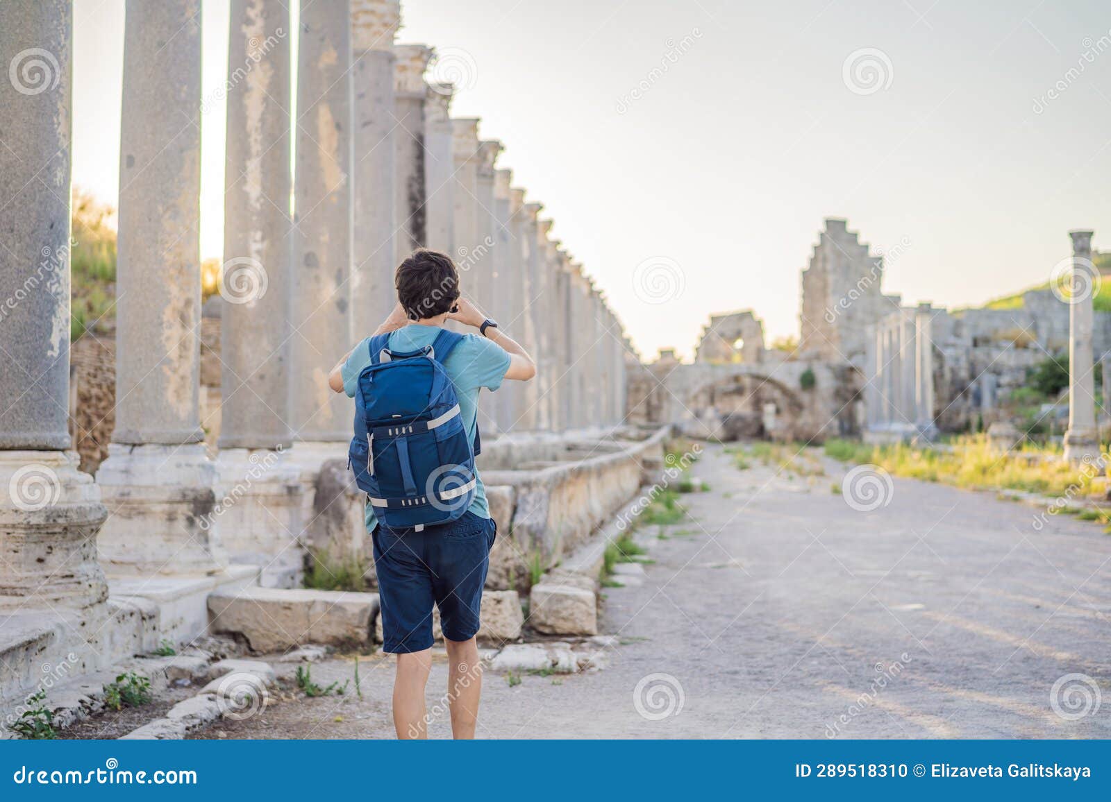 tourist man at the ruins of ancient city of perge near antalya turkey