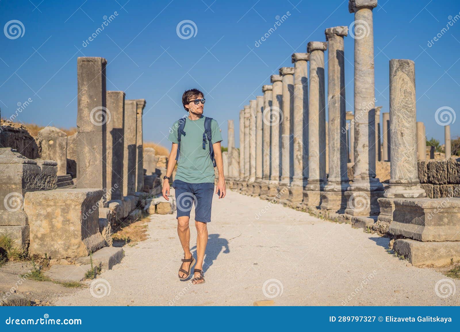 tourist man at the ruins of ancient city of perge near antalya turkey