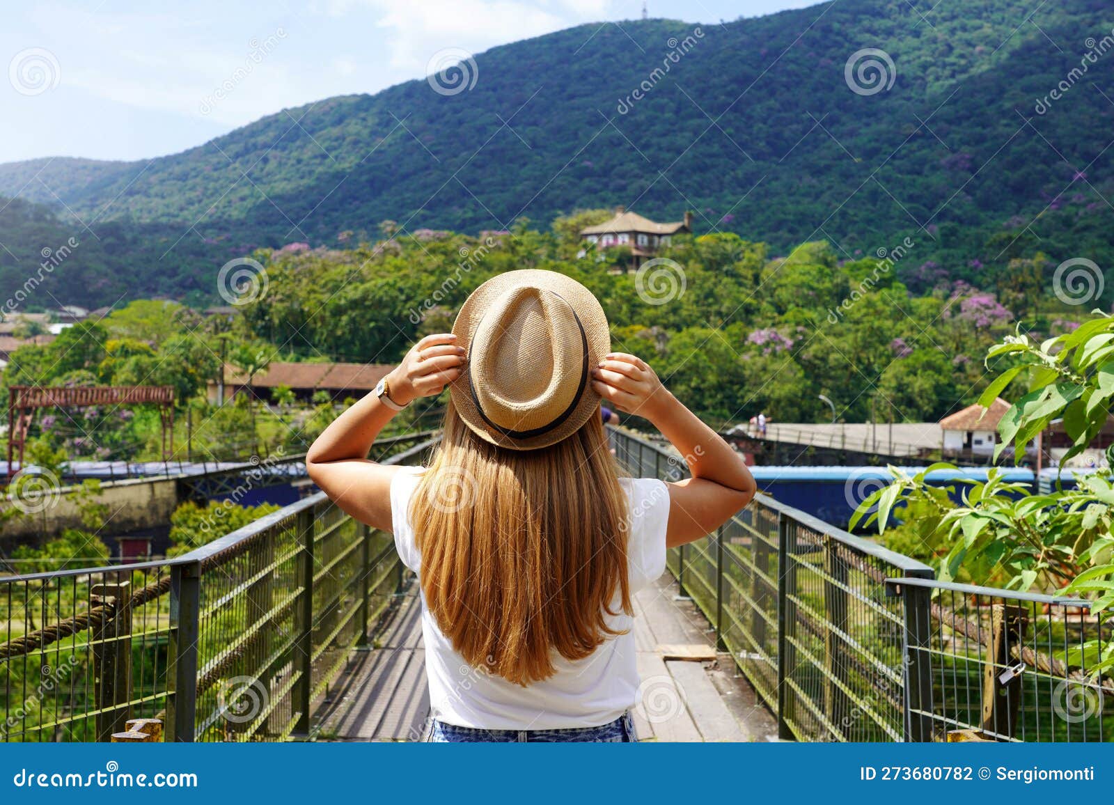 tourist woman walking on metallic walkway in paranapiacaba, rio grande da serra, brazil