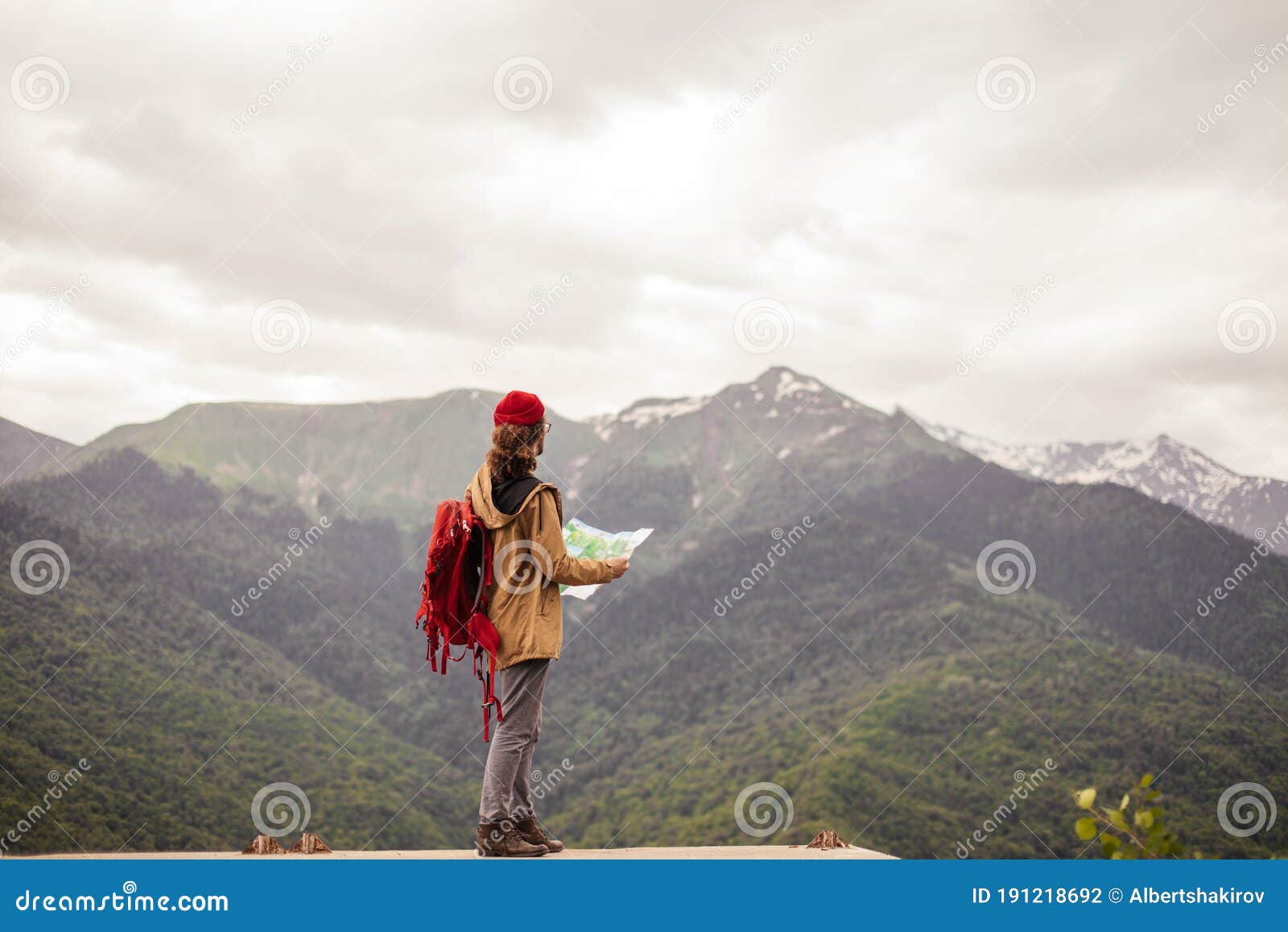 Man Traveler With Map And Red Backpack Searching Location Outdoor With Rocky Mountains On Background Stock Photo Image Of Extreme Discovery