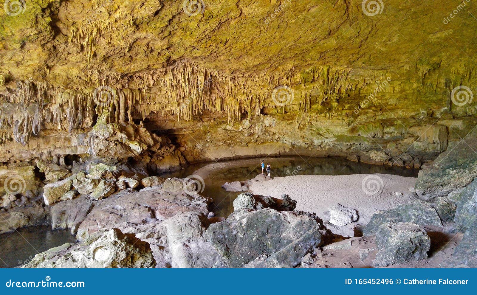 tourists on beach in rio frio caves, belize