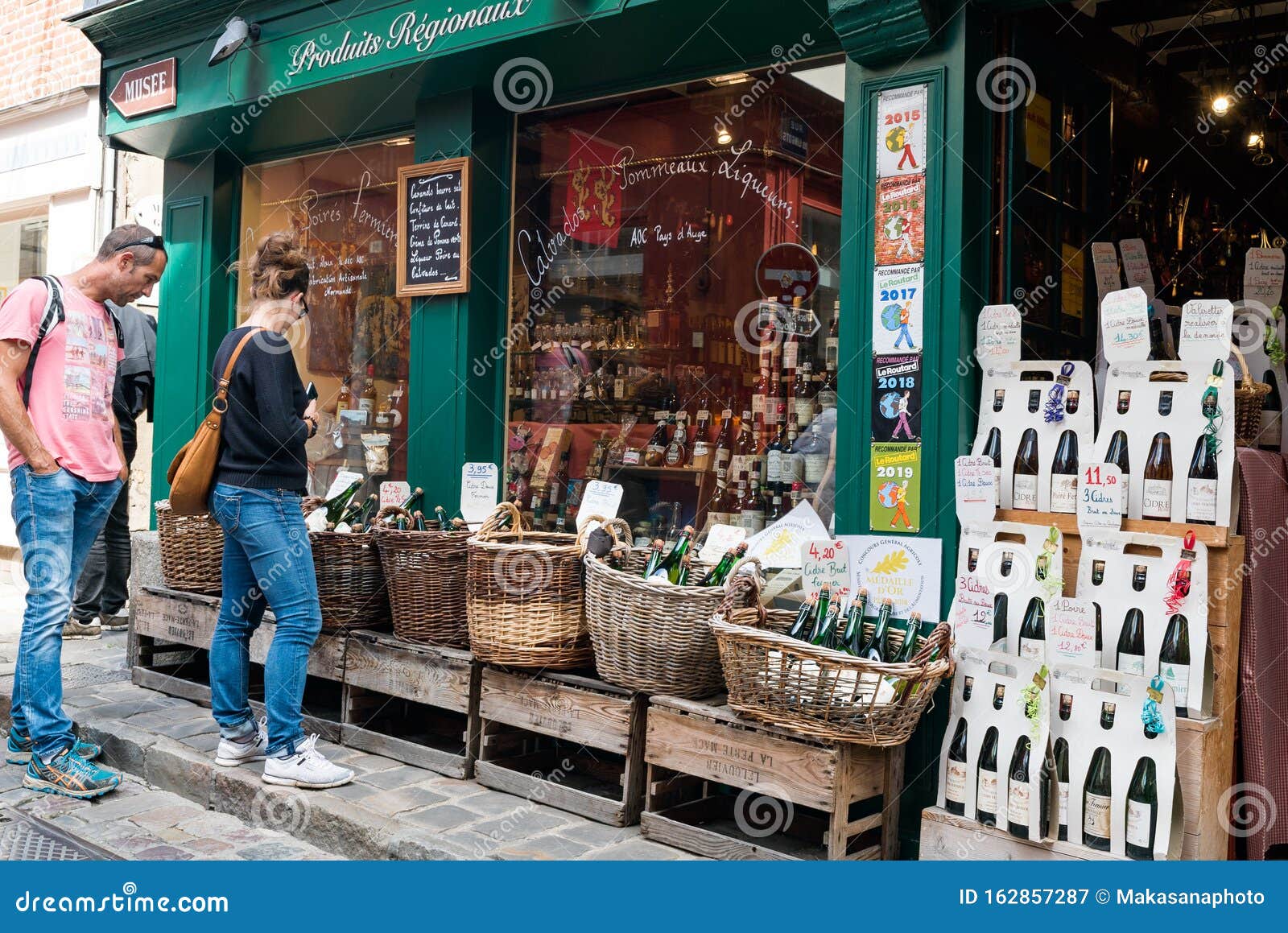 Tourists Browsing and Window Shopping at a Cider and Liquor Shop in ...