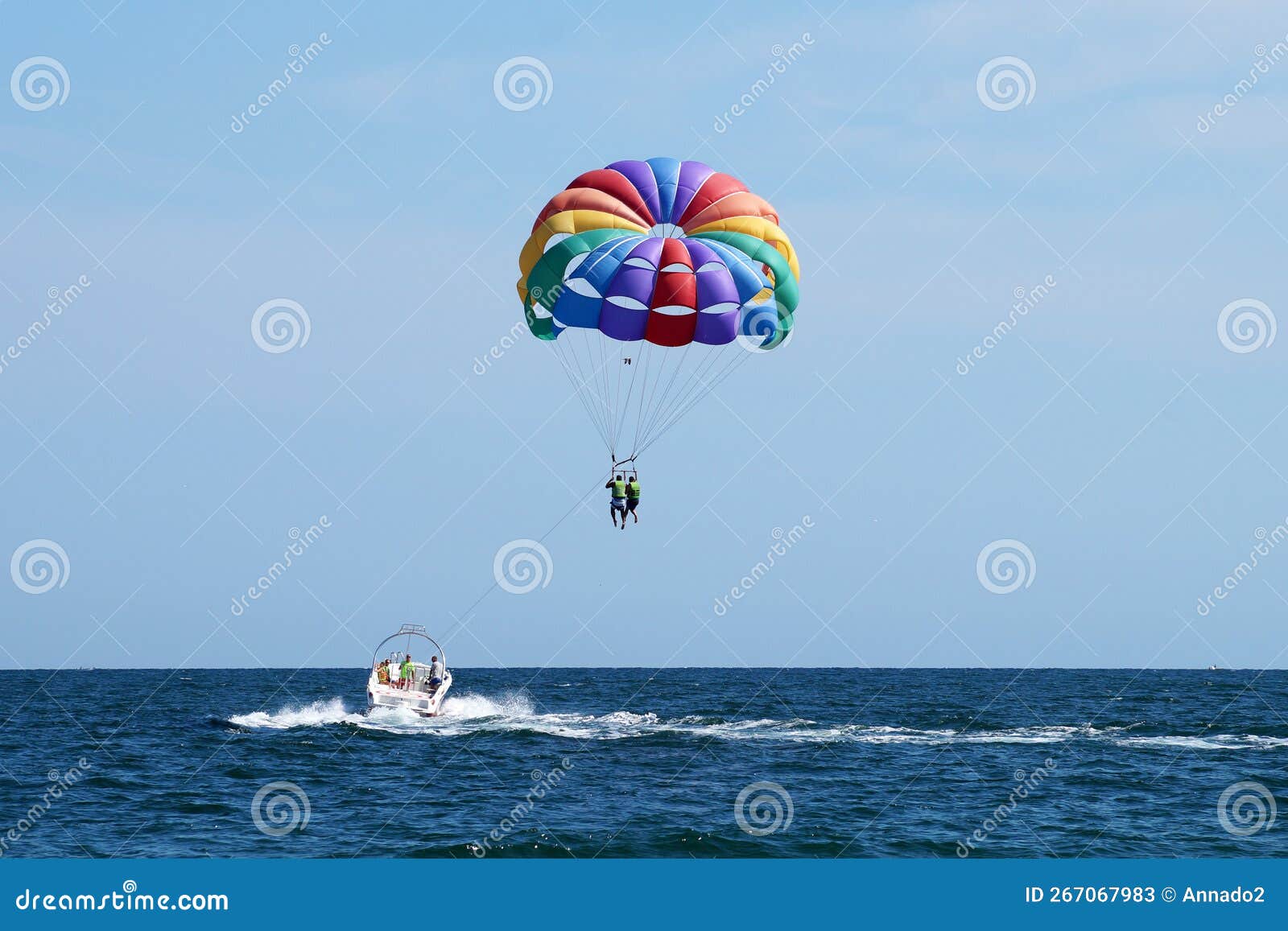 Tourists Flying on a Multicolored Parachute Tied To a Boat Editorial