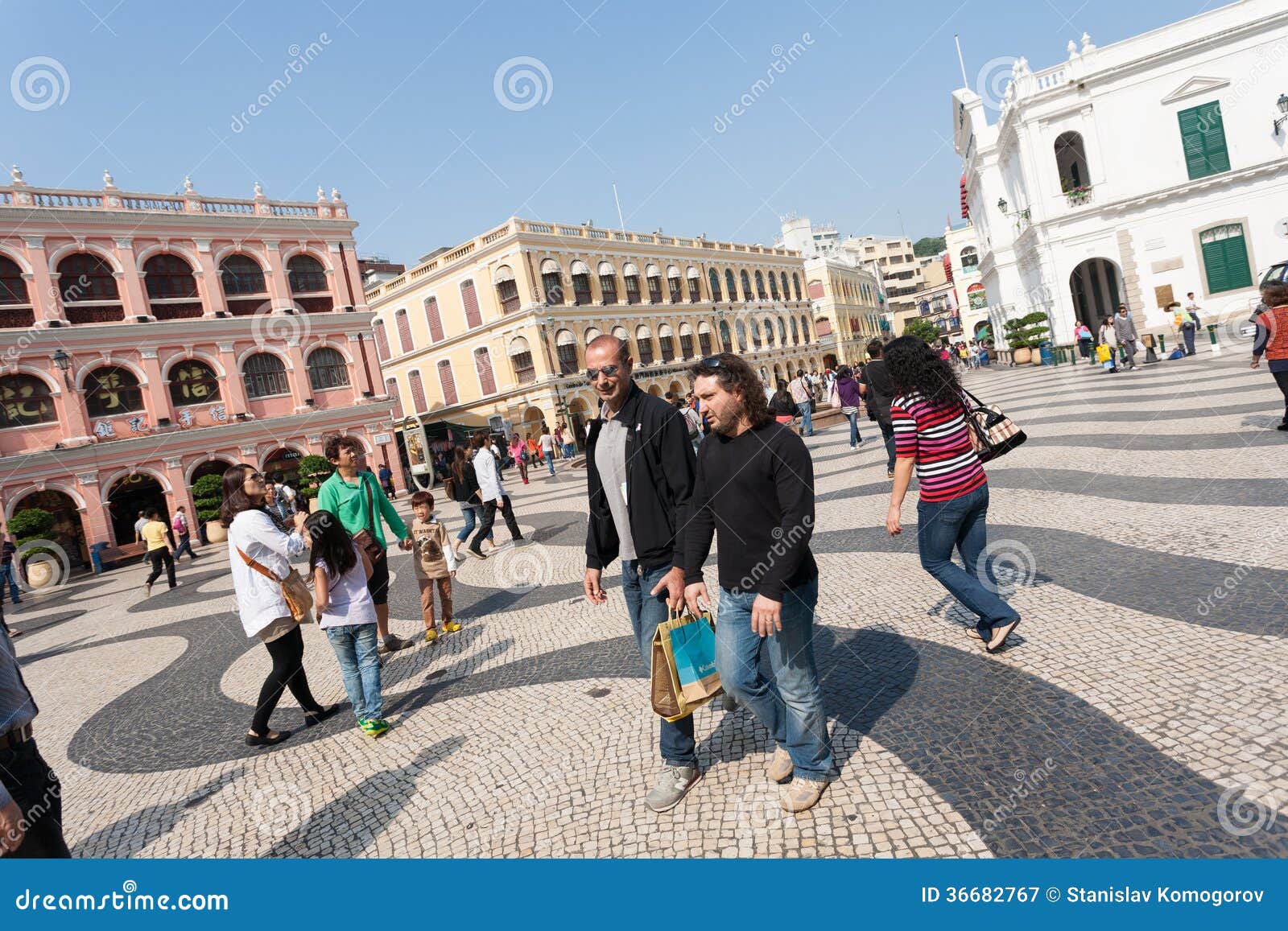 Tourists on the historic Senado Square in Macau. MACAU, CHINA - NOVEMBER 2, 2012: Tourists visit the Historic Center of Macau - Senado Square. Historic Center of Macau was inscribed on UNESCO World Heritage List in 2005.