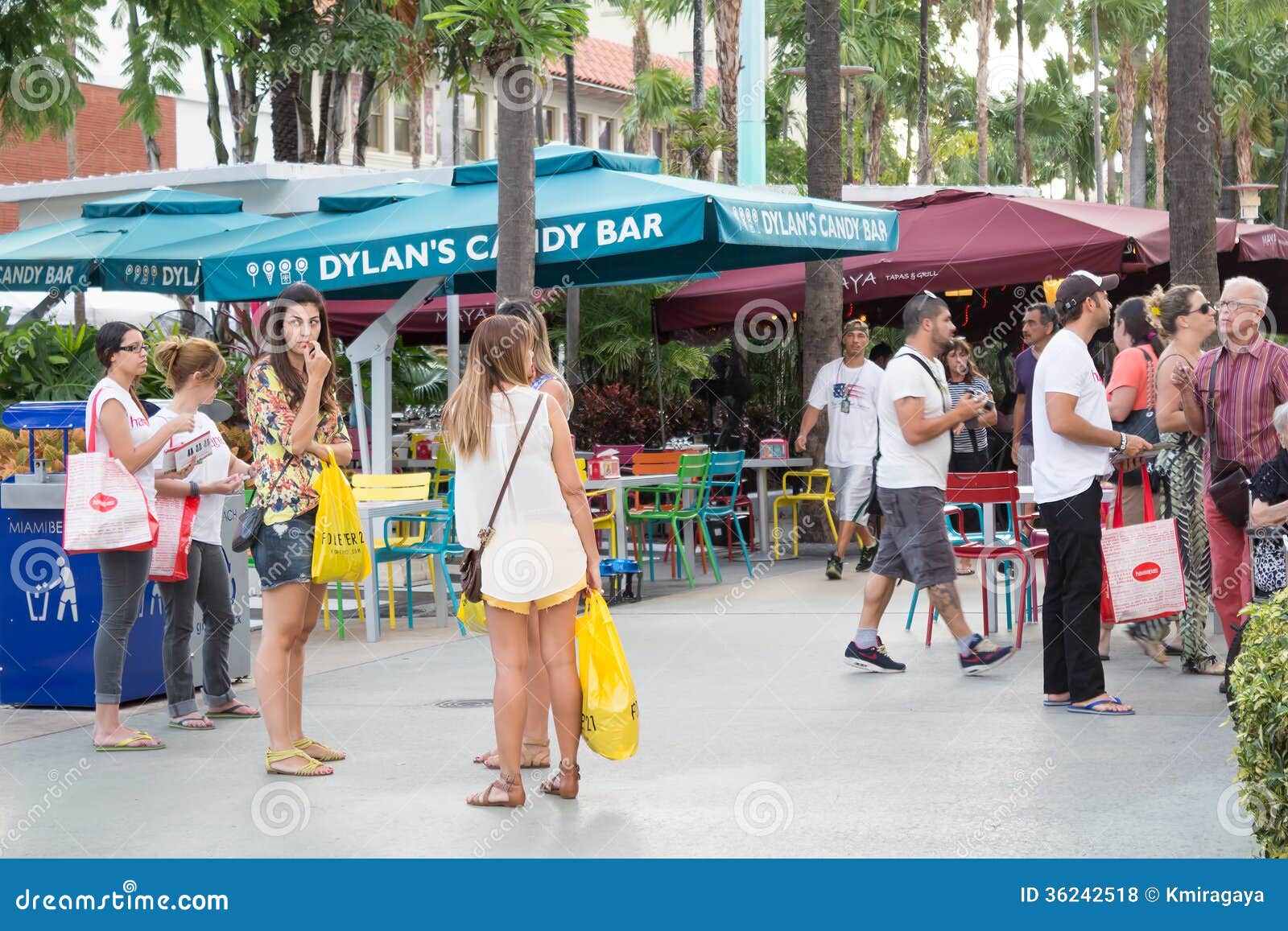 Tourists at Lincoln Road in Miami Beach. MIAMI,US â€“ NOVEMBER 24,2013:Tourists enjoying the warm weather at Lincoln Road in Miami Beach.This boulevard features over 200 designer boutiques,national retail stores and fine restaurants and bars