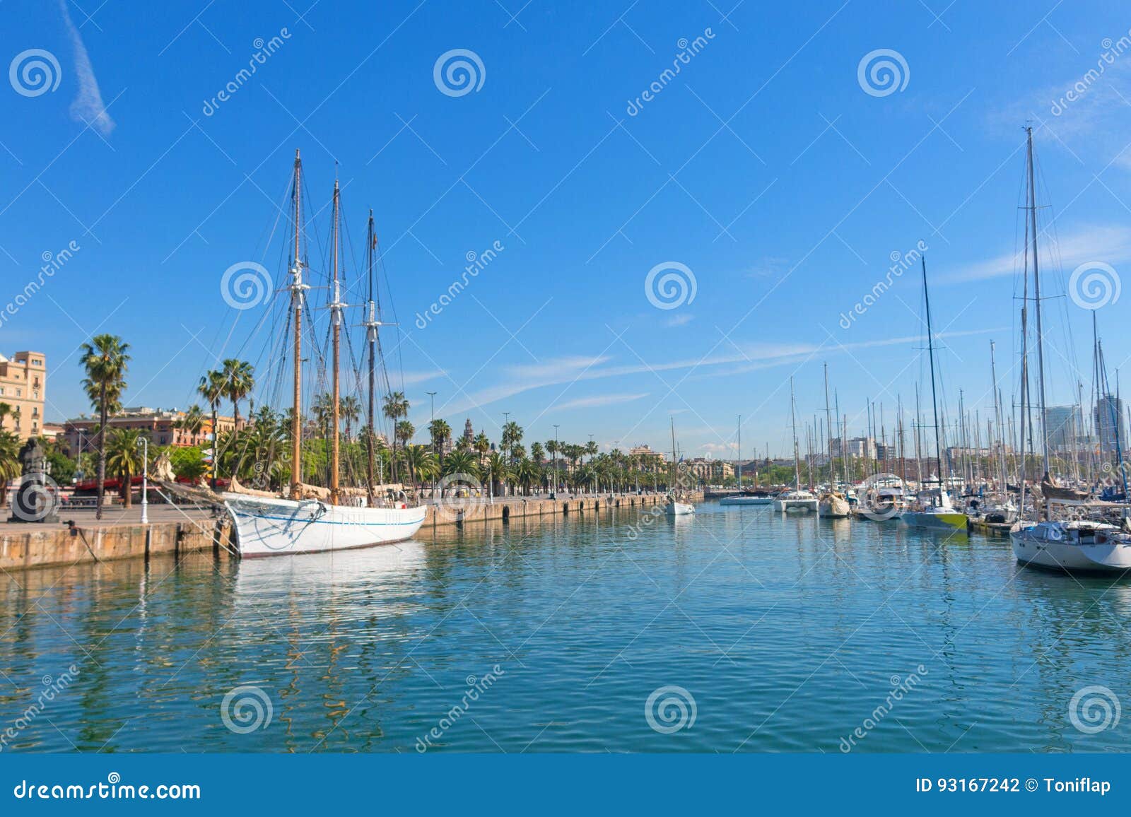tourists stroll along the port next to santa eulalia in barcelona, spain
