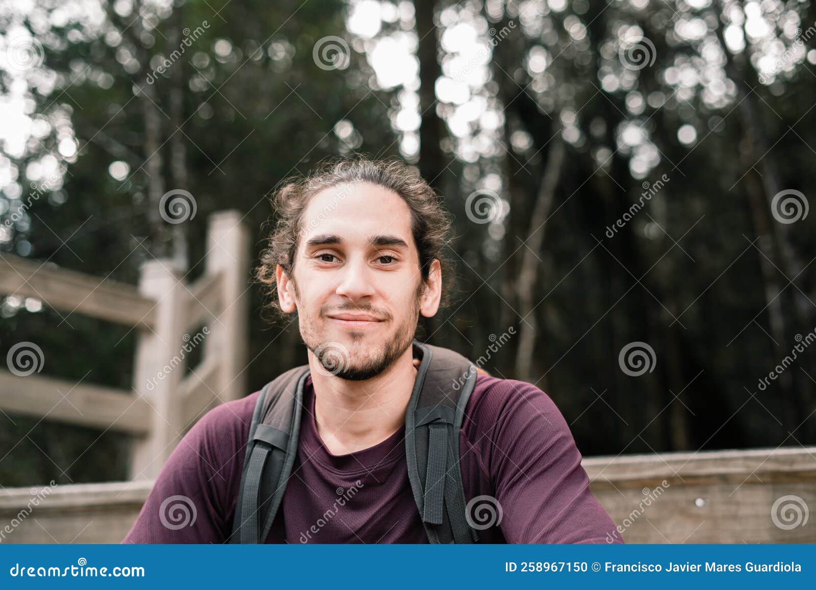 Tousled Caucasian Guy with Beard Sitting on Wooden Jetty Looking at ...