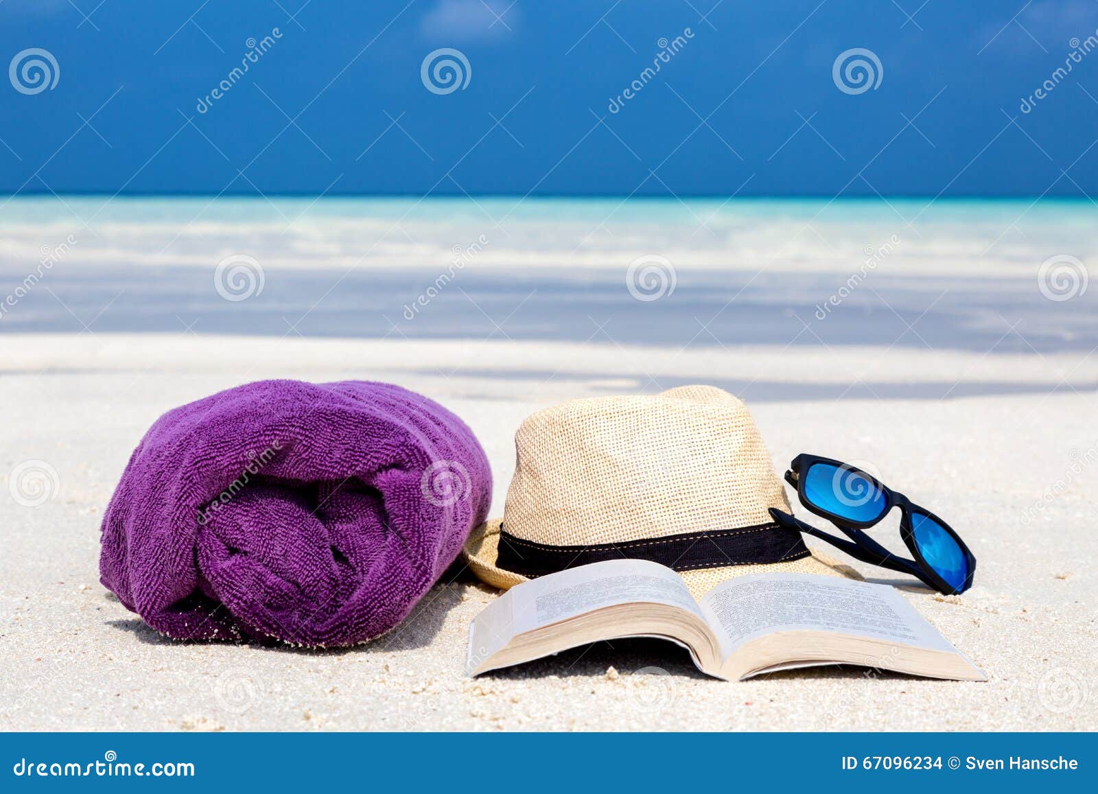 Towel, Hat, Sunglasses and a Book on the Beach Stock Photo Image of