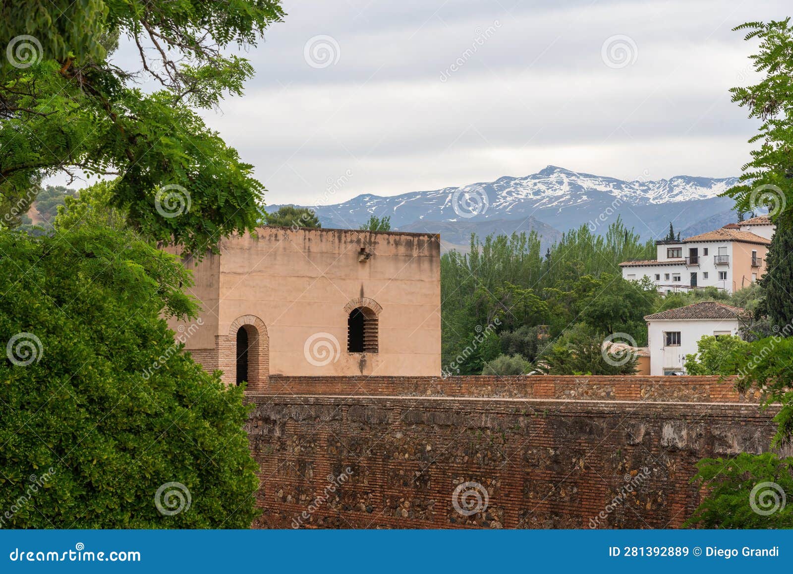 tower of baltasar de la cruz at alhambra with sierra nevada mountains - granada, andalusia, spain