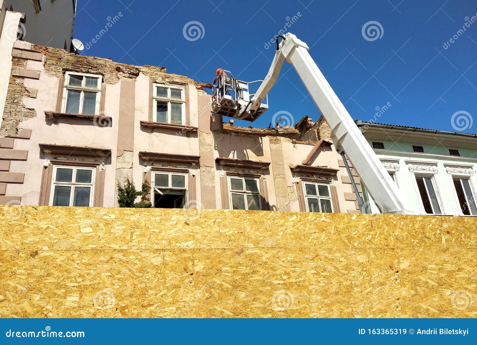 Tower of Lift Crane and Old Building Under Dismantling Stock Image