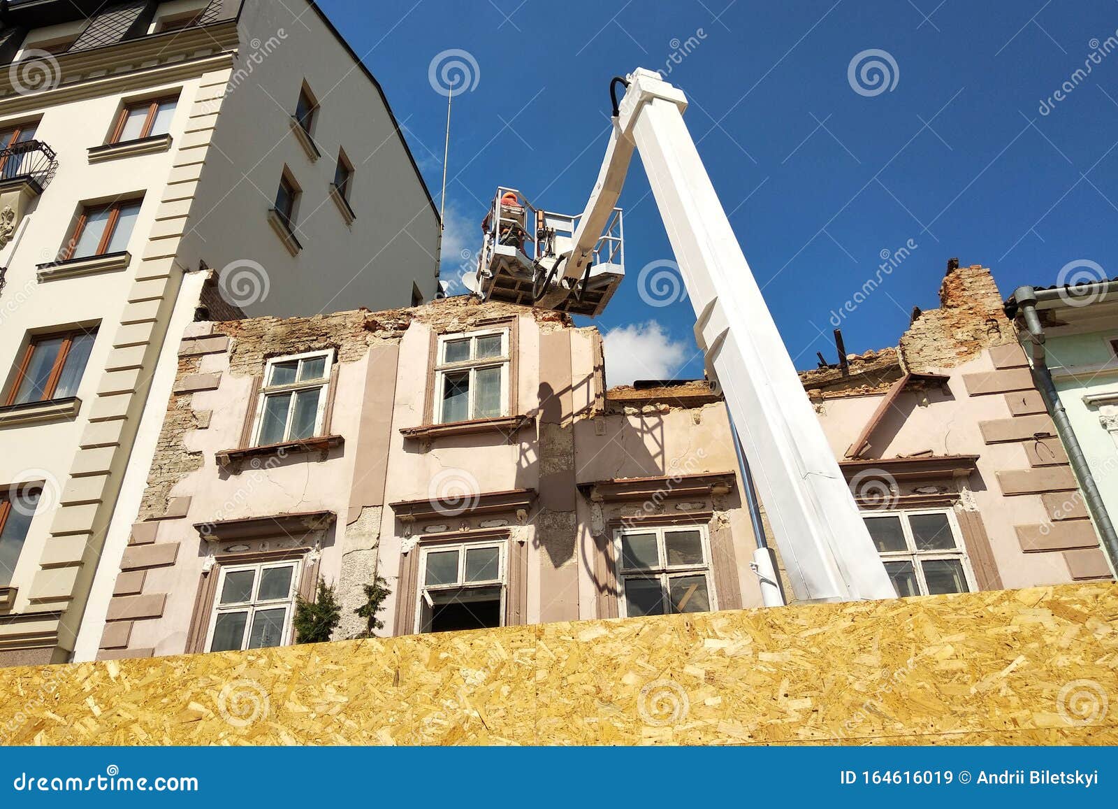 Tower of Lift Crane and Old Building Under Dismantling Stock Image