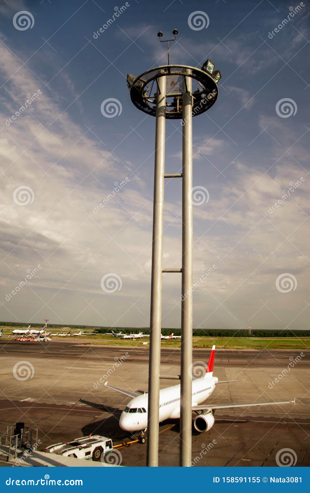 Tower of Lighting and Equipment at the Airport on a Background of Blue