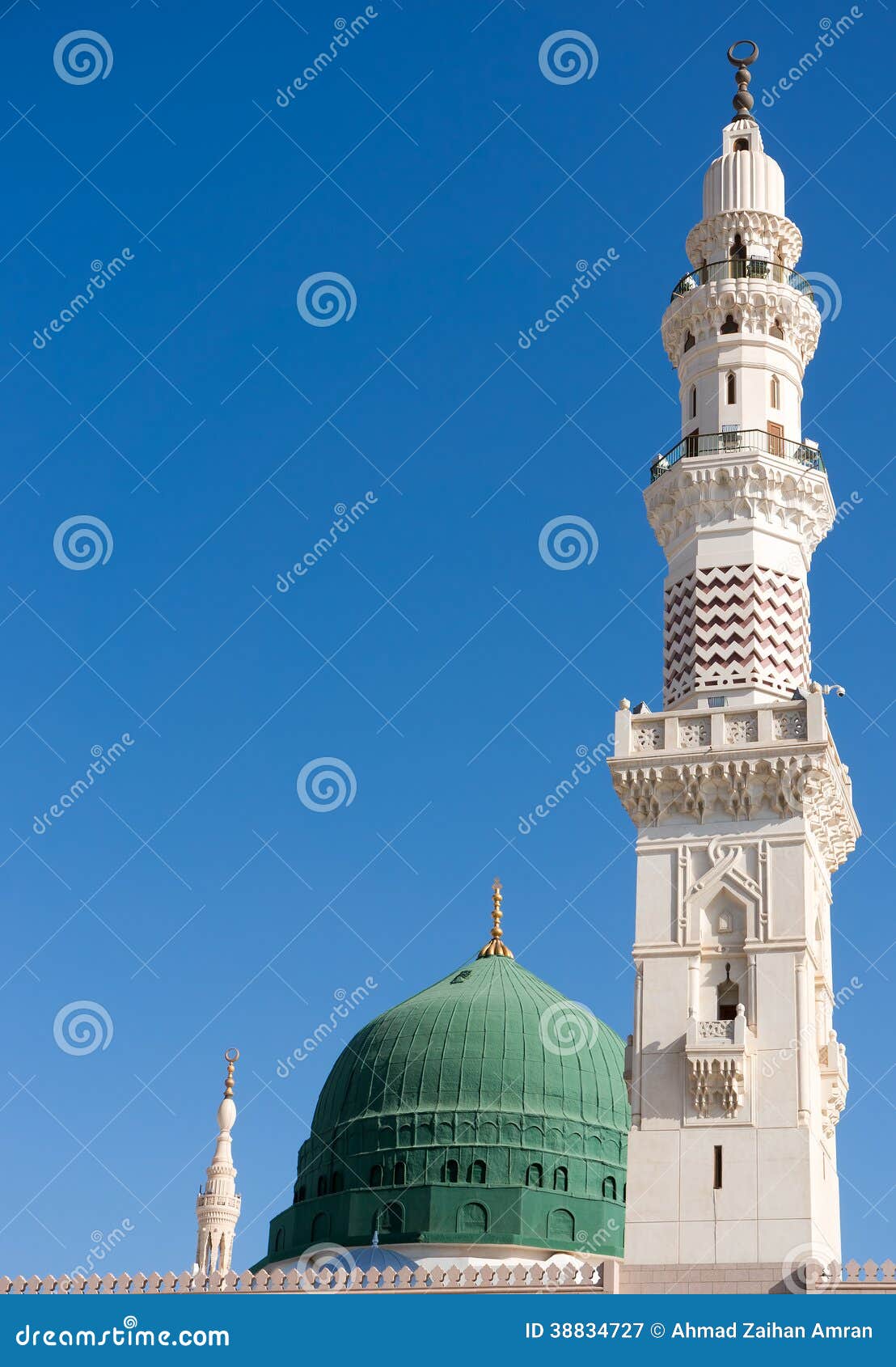 tower of the nabawi mosque againts blue sky