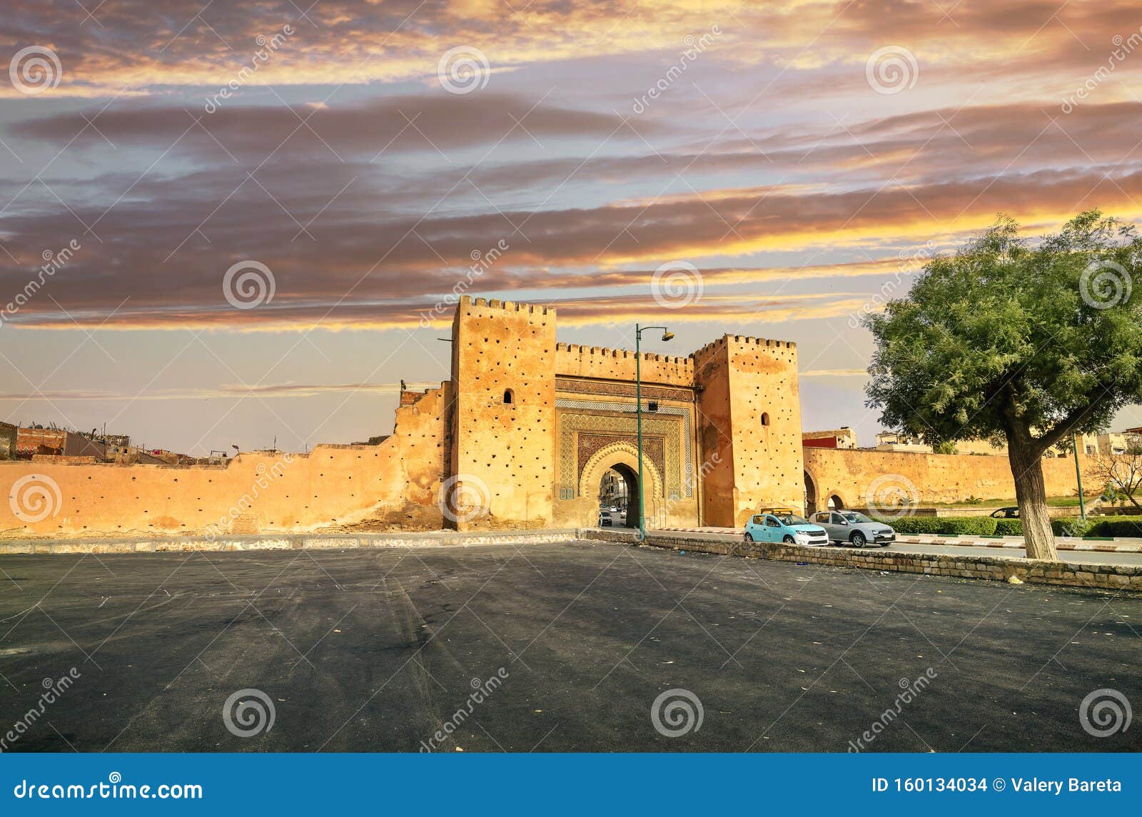 town wall and gate bab el-khamis in medina of meknes at sunset. morocco