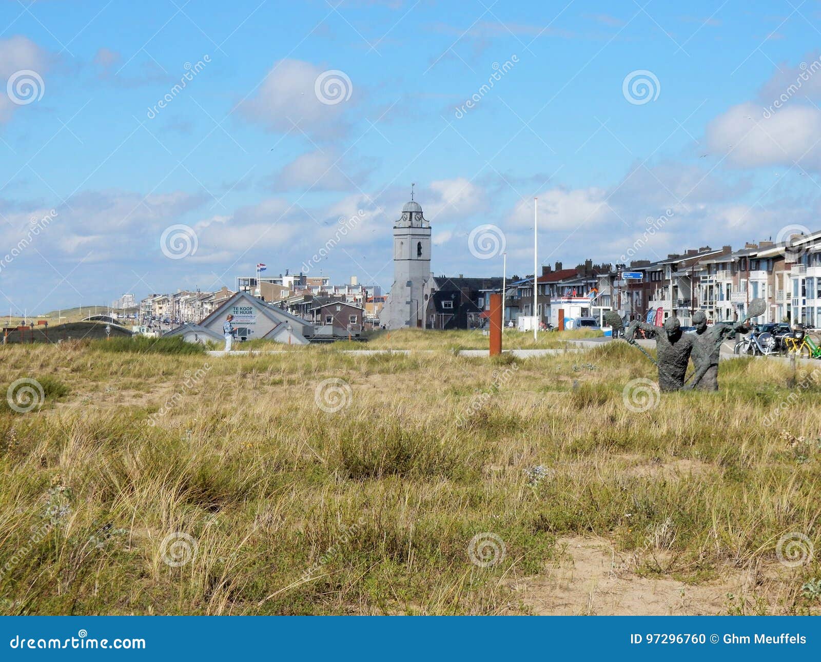 townscape katwijk aan zee with church, dwellings and dunes with grass