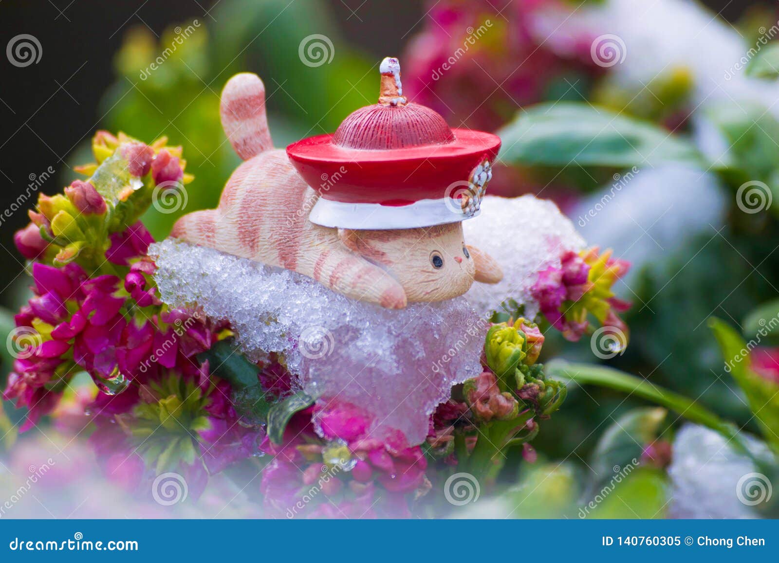 toy cat lie prone on ice of flowers