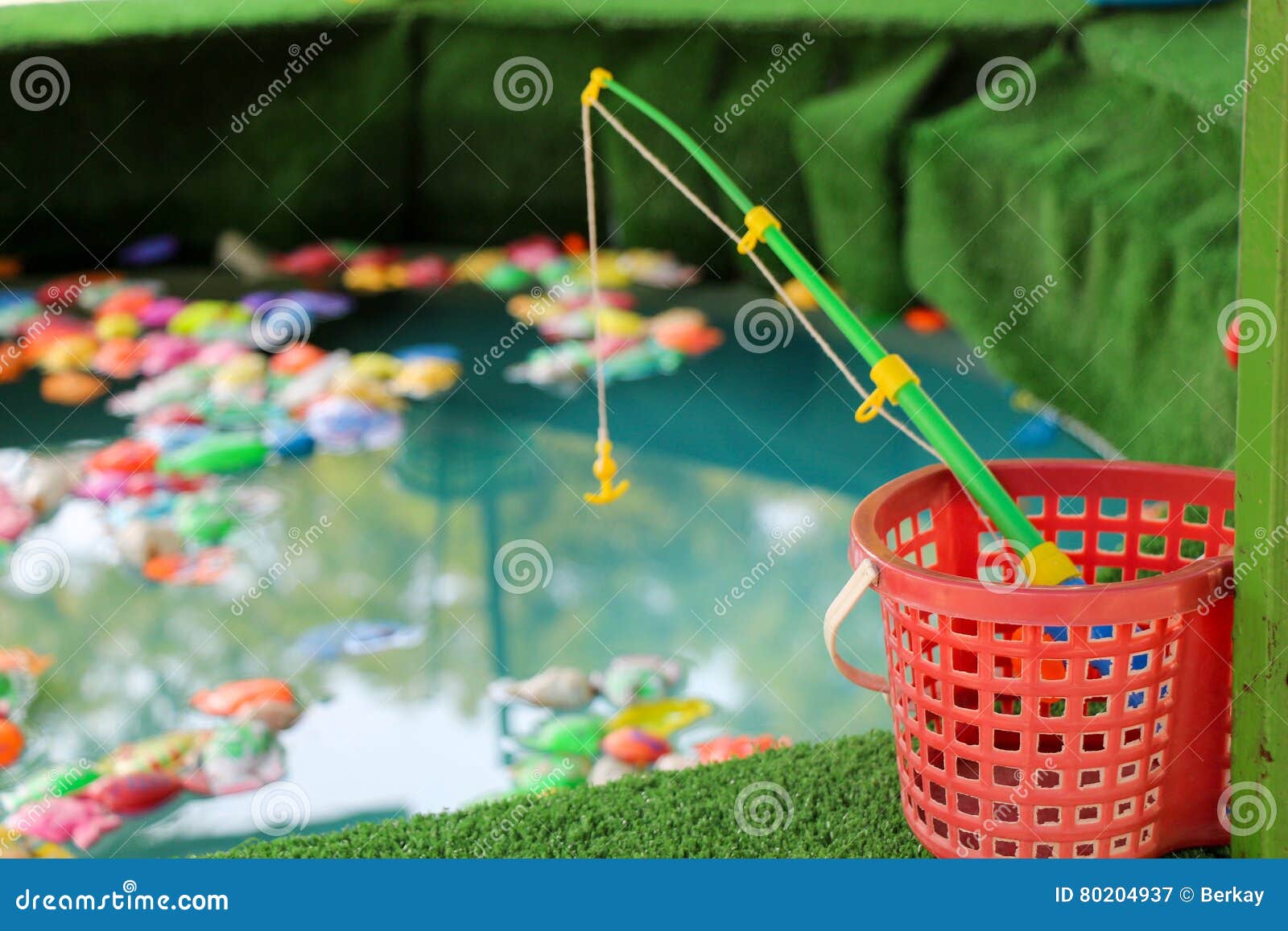 Toy Fishing Rod and Fake Fish in the Pond Stock Image - Image of