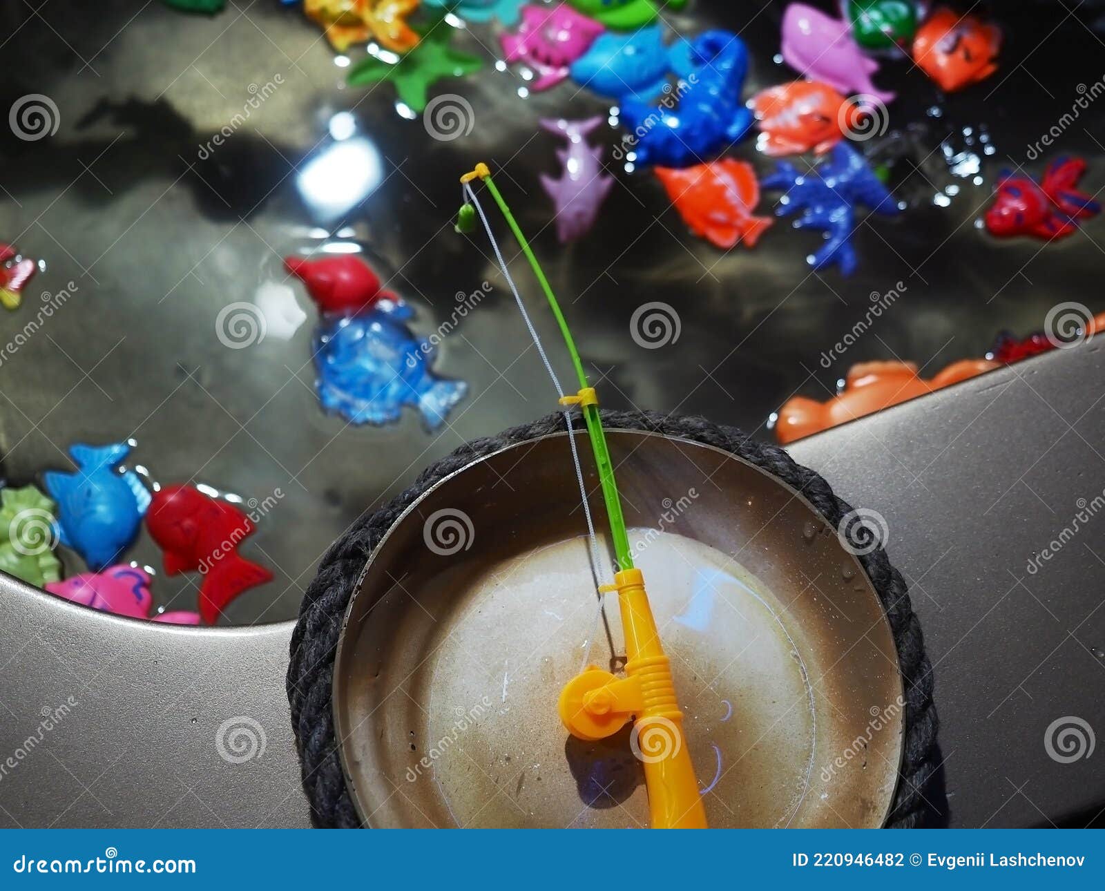 A Toy Fishing Rod Hangs Over a Miniature Pool with Plastic Colorful Fish.  Child Game Stock Photo - Image of park, toddler: 220946482