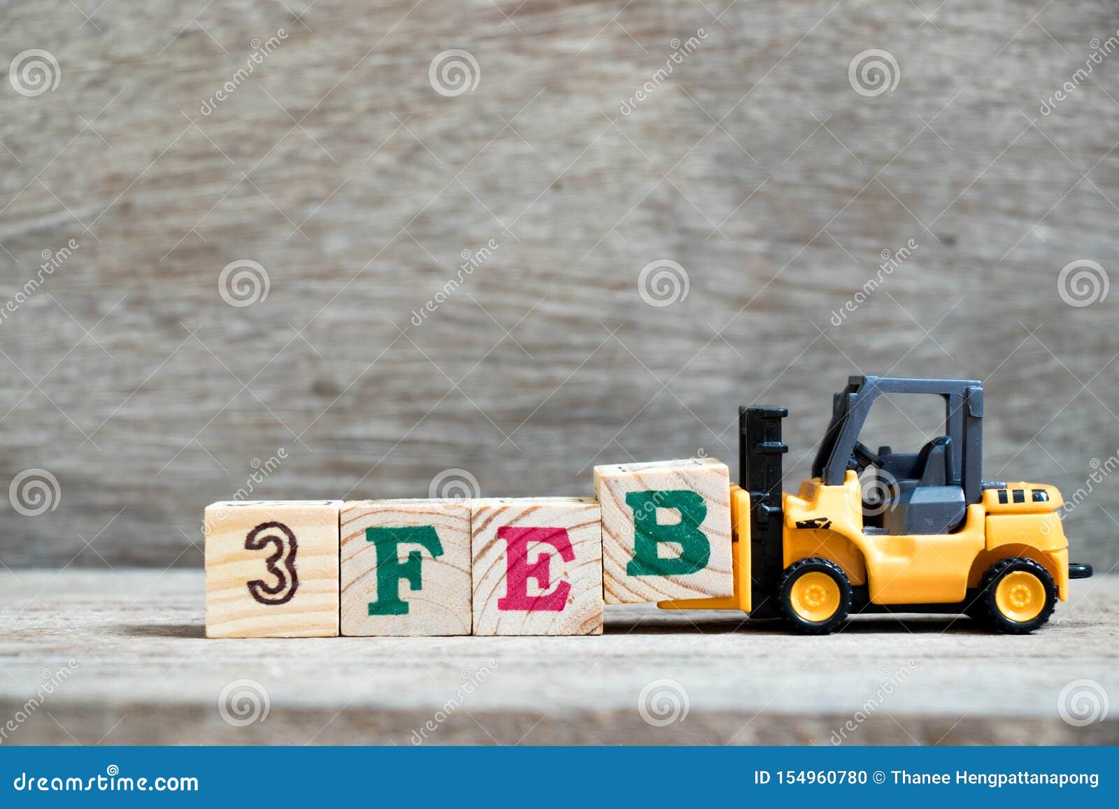 toy forklift hold block b to word 3feb on wood background concept for calendar date 3 in month february