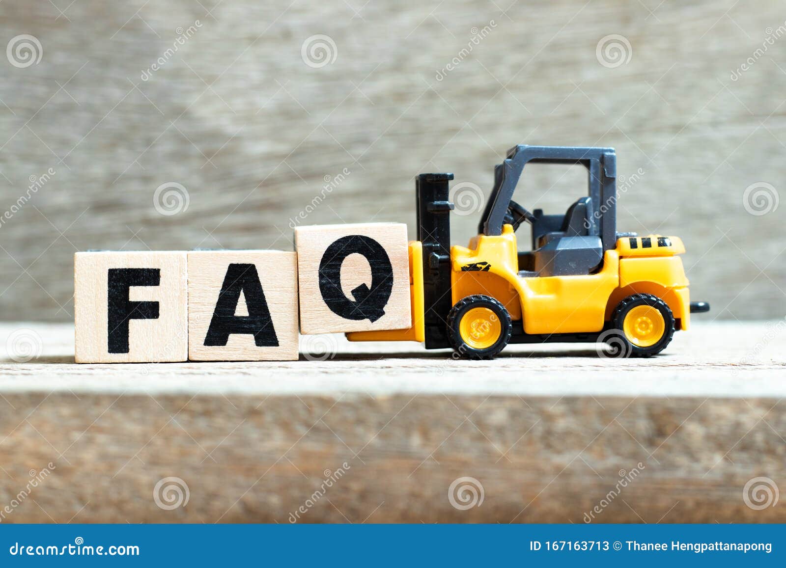 toy forklift hold block q to complete word faq abbreviation of frequently asked questions on wood background